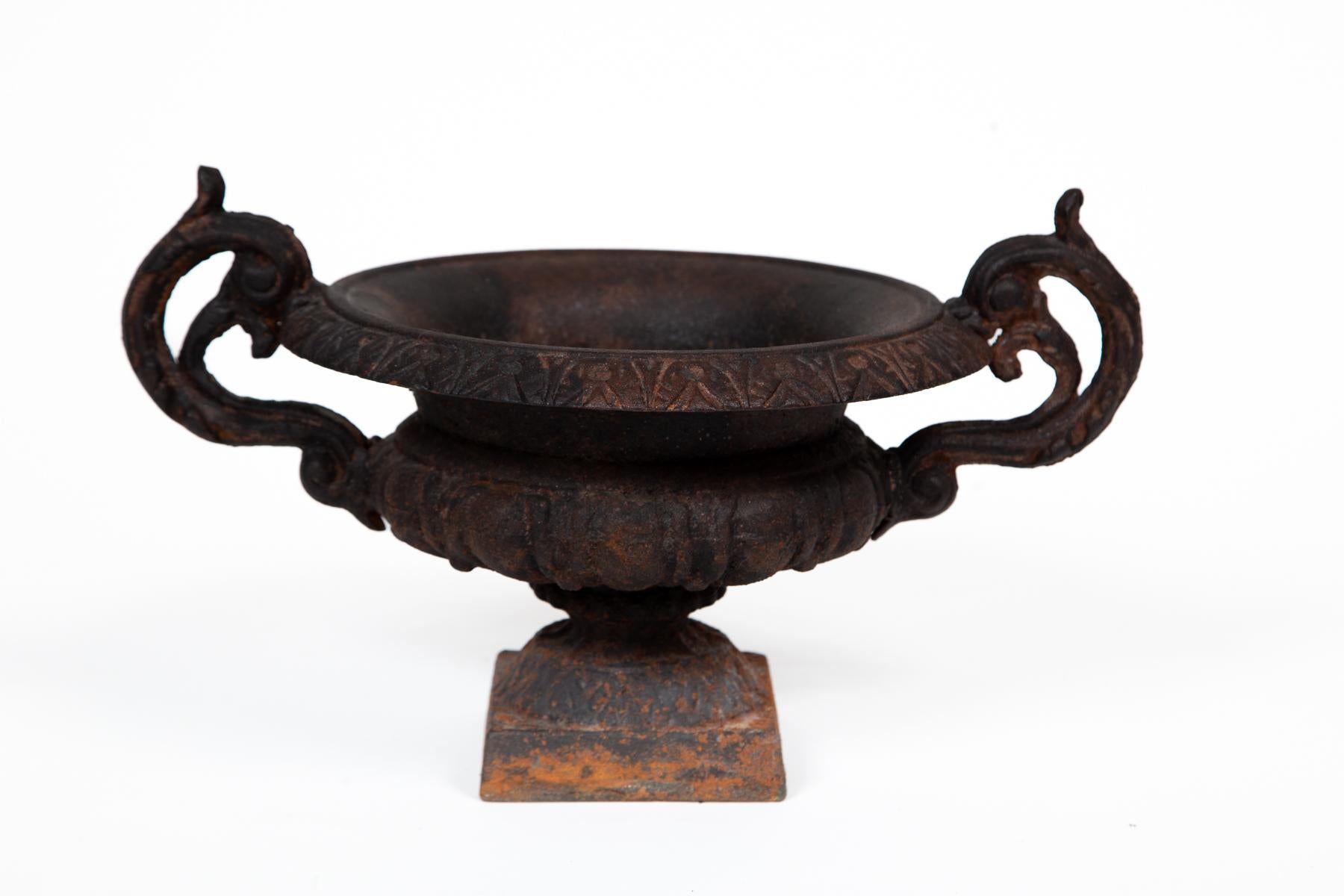Cast Iron Chambord Style Garden Urn, France, circa 1910. A petite size with weathered finish and scroll style handles. 