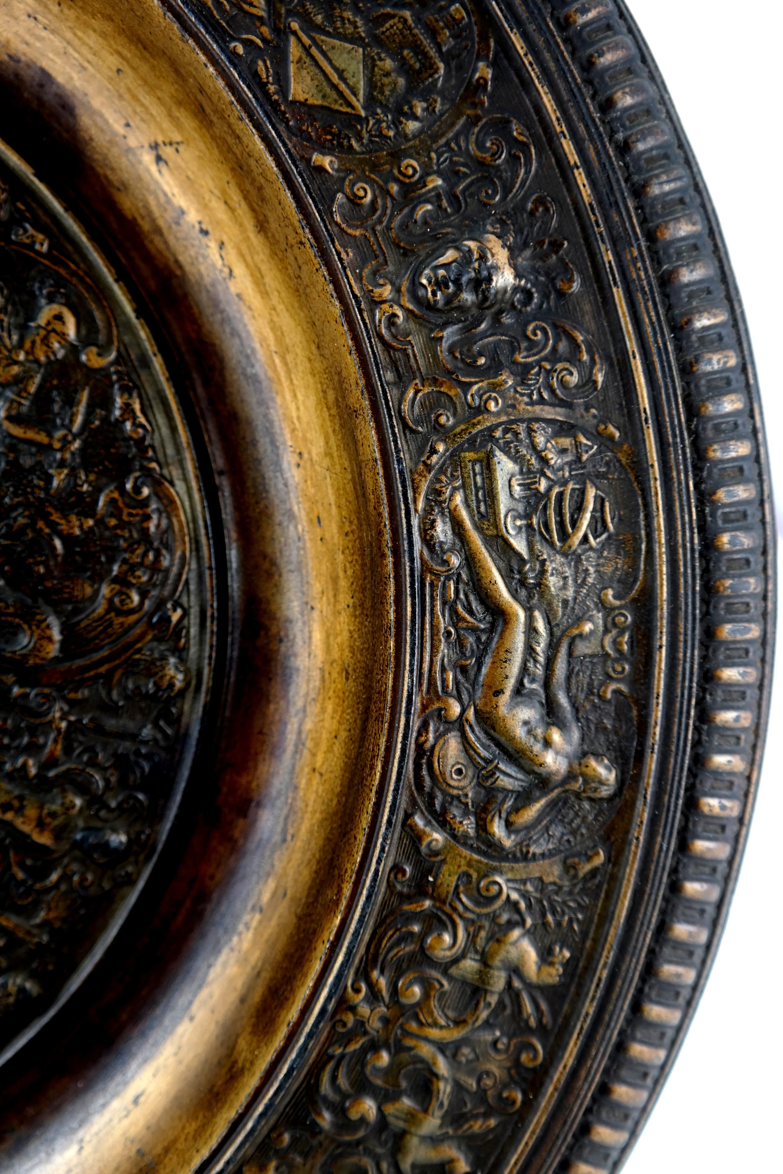 Cast iron charger with mythological scenes
Signed: ANINA
Early 20th century. Heavy cast iron charger of round form decorated throughout in roman style with historical or mythological figures.
   