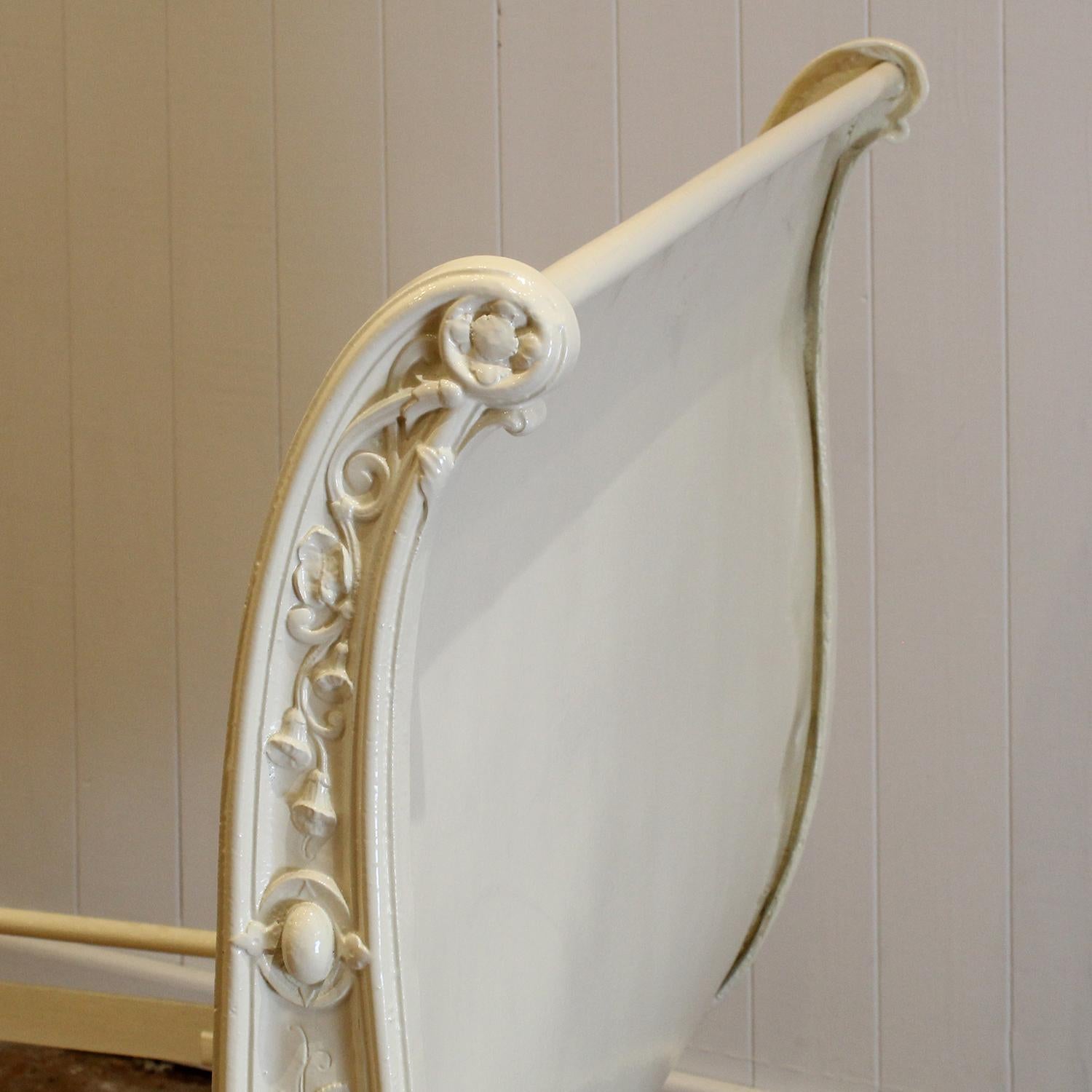 A superb dainty cast iron French day bed, with roule shape ends and ornately cast front side, with a central depiction of a cherub flanked by lines of roses.

The price of this day bed includes a shallow base and a Victoria mattress suitable for