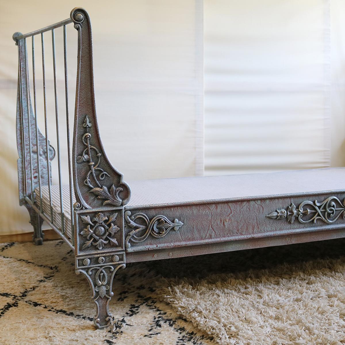 A fine cast iron daybed with ornate cast panels finished in hand paint Blue Verdigris.

This bed accepts a 32 inch wide by 70 inch long base and mattress set.

The price includes a shallow firm base and a medium/firm Victoria mattress suitable