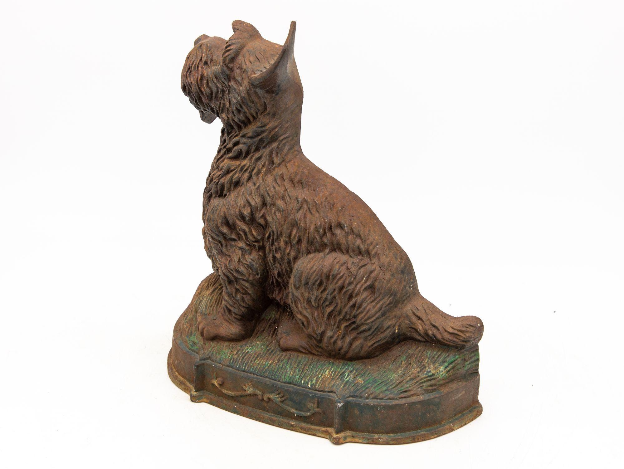 Crafted with exquisite detail, this English early 20th Century cast iron door stop is shaped like a charming Scottie dog, evoking a lifelike presence. The intricate design captures the essence of the Scottie breed, with its distinct coat texture,