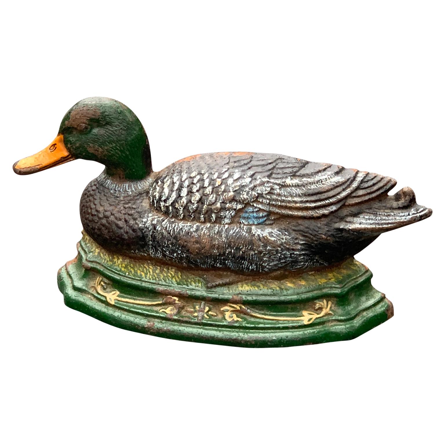 Painted cast iron duck door stopper.