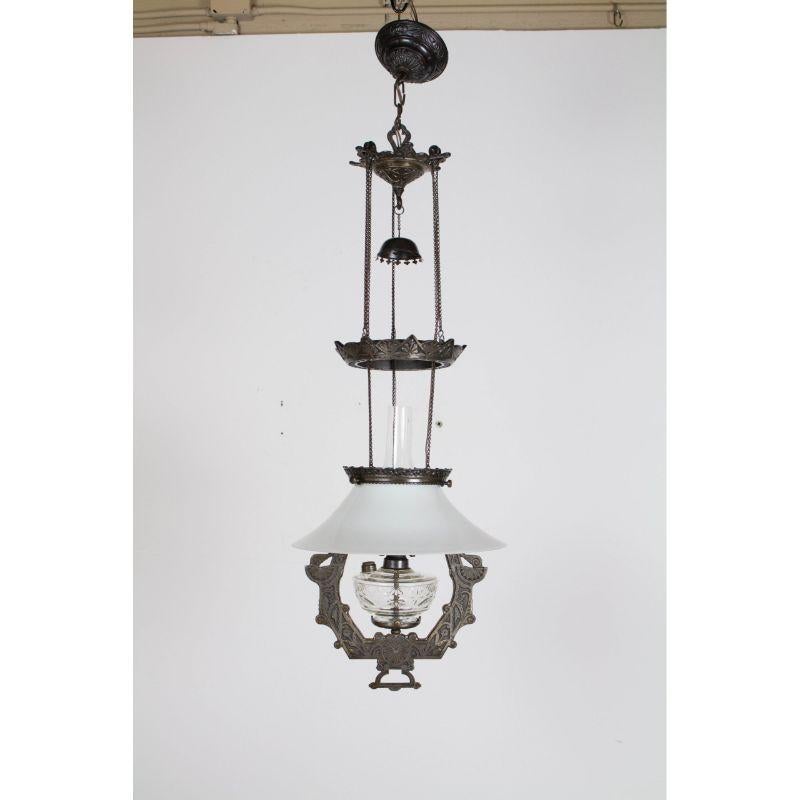Eastlake Style Oil Pendant by Lomax. Has original oil font and glass shade. Completely restored and carefully converted to electricity.  Ready to install. Iron is protected from rusting. Beautiful geometric patterns on iron and on glass font.