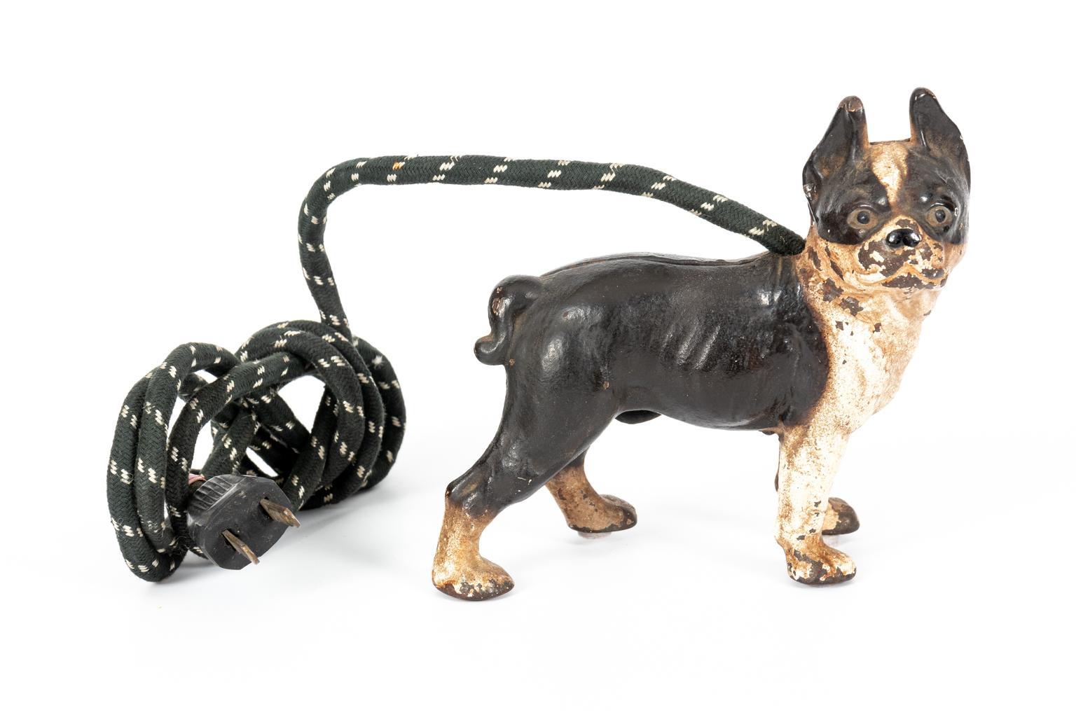 Circa 1928 electric cigarette lighter made by Vindex. The cigarette lighter is in the back and under the tail while the on- and-off switch is located on the belly. The chord comes out of the back of the dog's neck. In working condition. Made in the