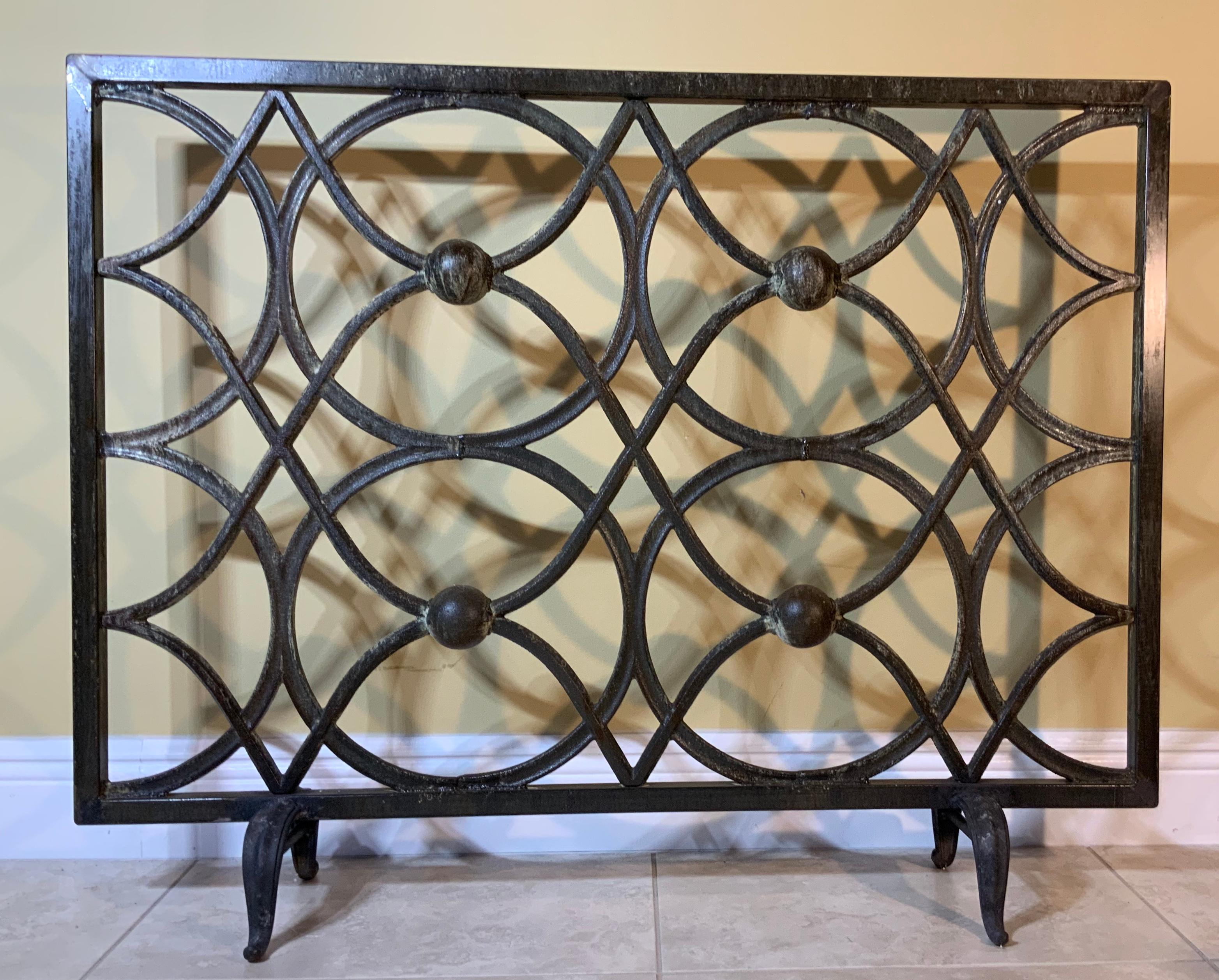 Elegant fireplace screen made of cast iron, artistic circular motif all around with great looking patina. Treated and sealed for rust.
Beautiful object of art for the fireplace.