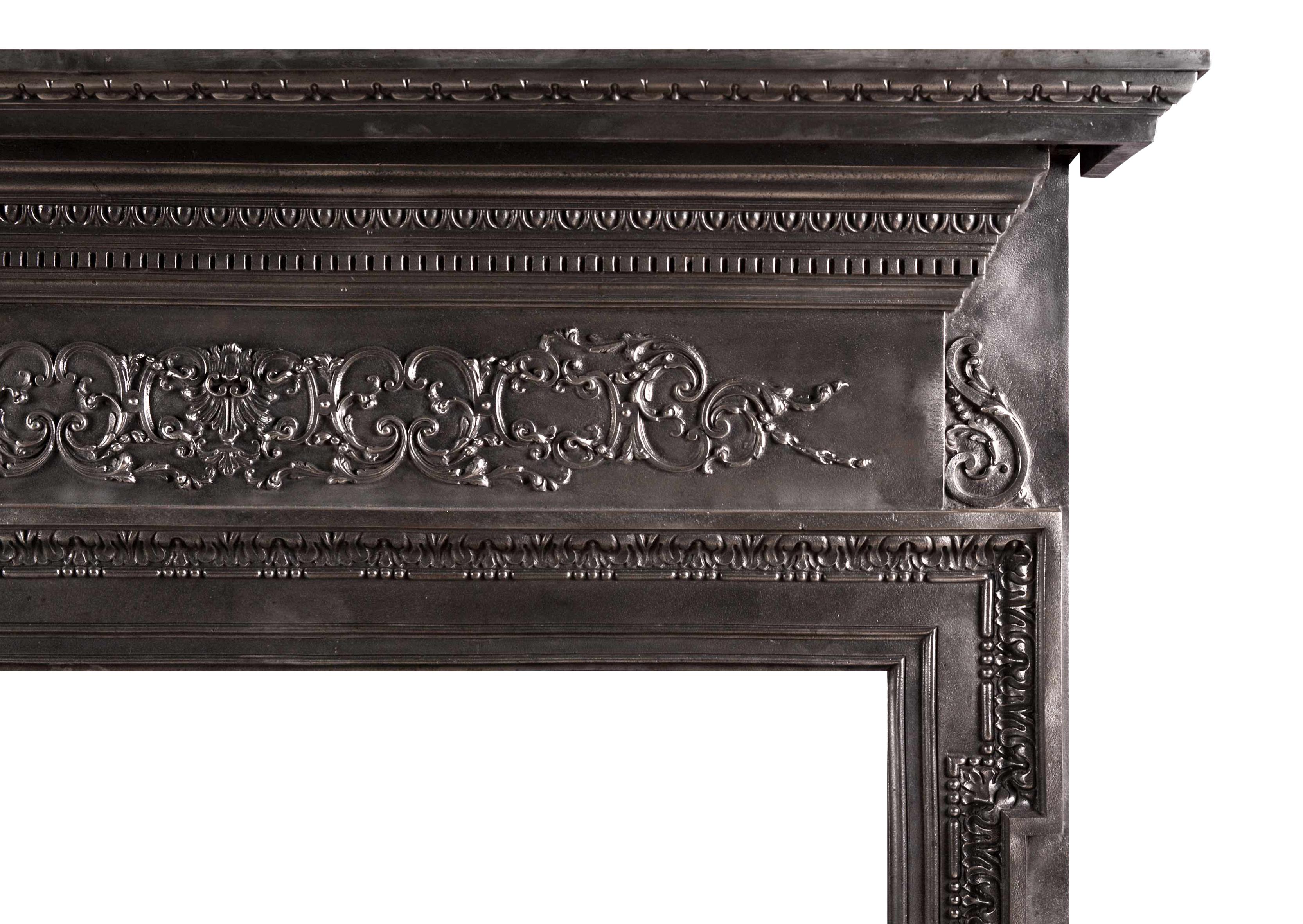 A late 19th century cast iron fire surround. The filigree detailing to the frieze with scrolls and foliage, and jambs with bellflower drops and leaf molding. The shelf with dentil and egg and dart moldings.

Measurements:
Shelf width:           1290