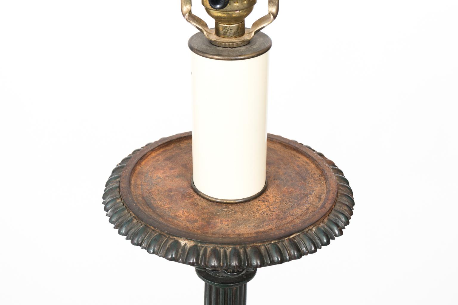 Floor lamp in the neoclassical style with lion's paw feet on a tripod base, circa late 19th century. Shade not included. Please note of wear consistent with age including oxidation at the top of the lamp along with a chip on the gadroon trim.