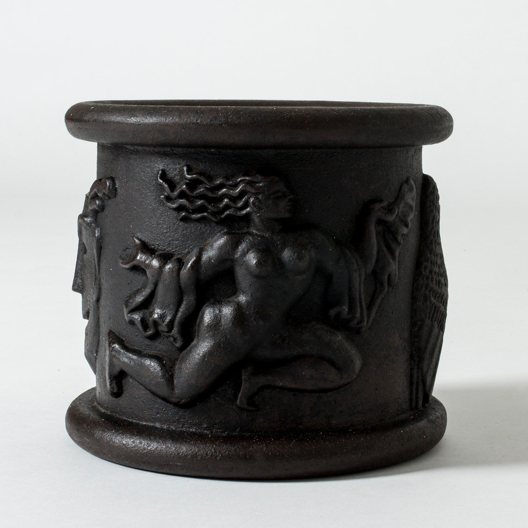 Flower pot #1 in cast iron, designed by Anna Petrus in 1925. The design was originally for the columns in the Swedish pavilion at the World Exhibition in Paris, and was subsequently adapted for the pots.
Bold motifs of women with flowing capes,