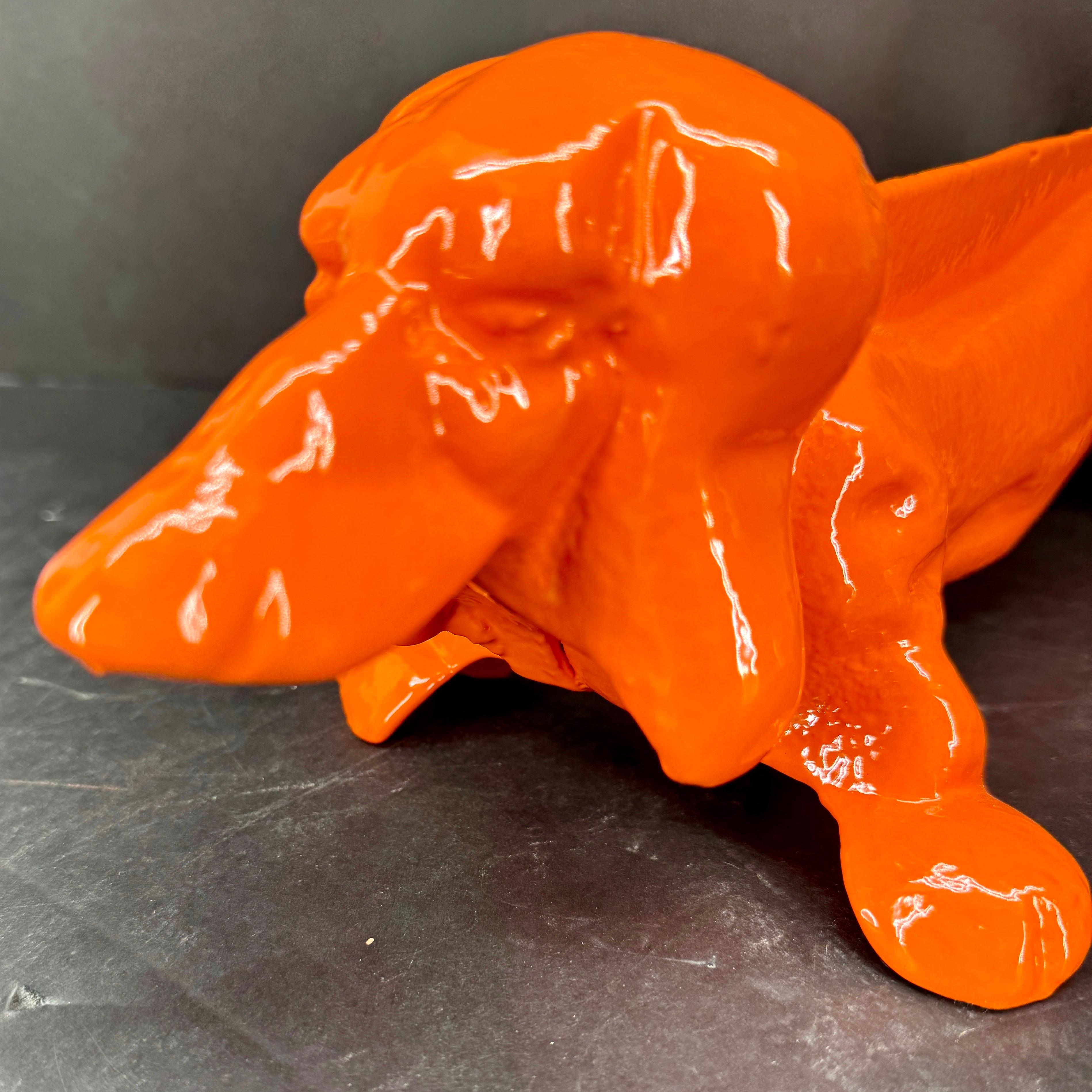 Dachshund cast metal boot scraper or door stop powder-coated in a fantastic shade of orange. Add a pop of color with this one-of-a-kind piece in your foyer, mud room or kitchen area. Makes a great gift for any animal lover as well. 