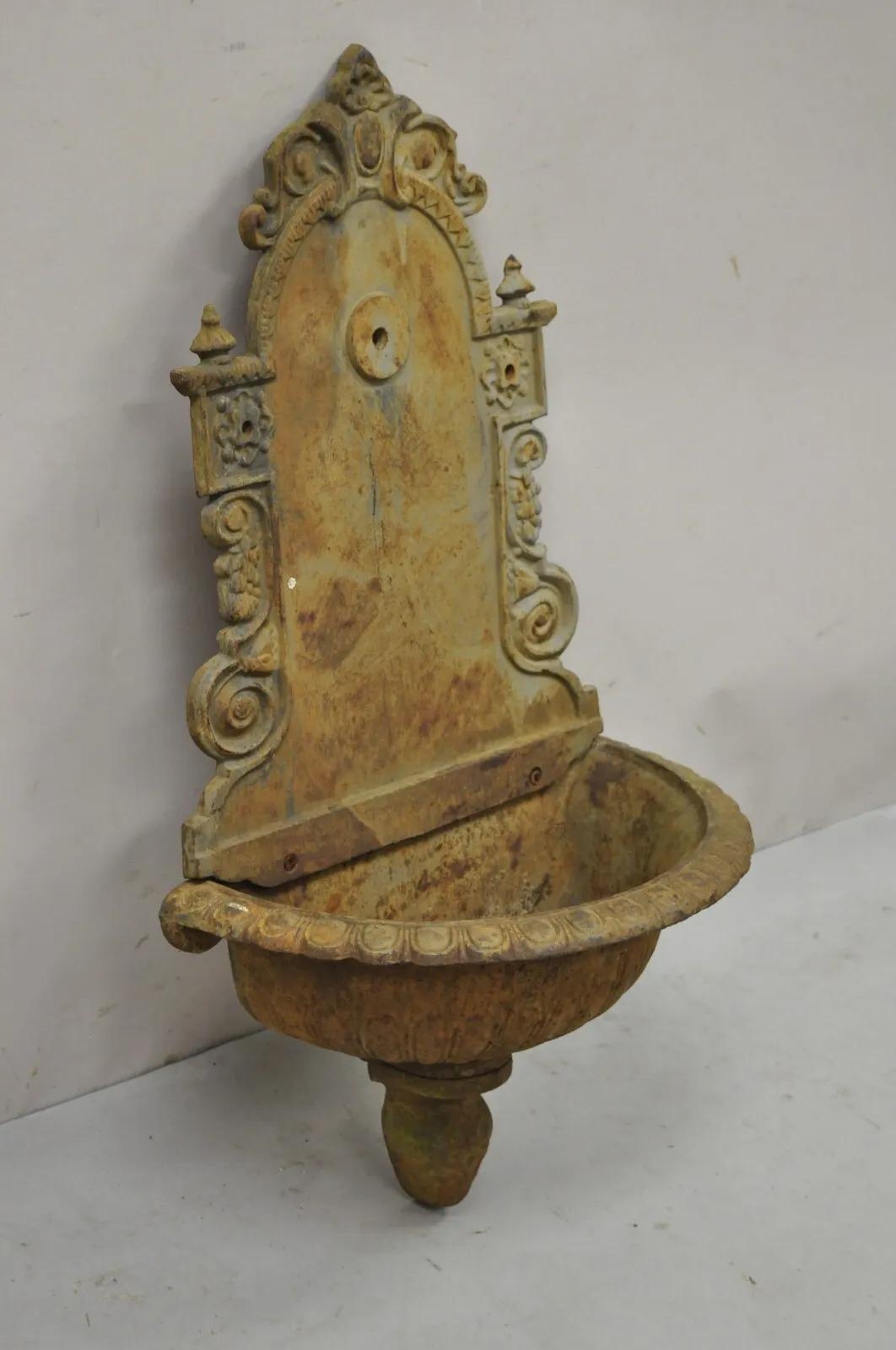 Cast Iron French Empire Neoclassical Style Outdoor Garden Wall Water Fountain. Item featured is a heavy cast iron construction, desirable weathered patina, approx. 45 lbs. each. Does not include mounting hardware or water pump service. Circa Late