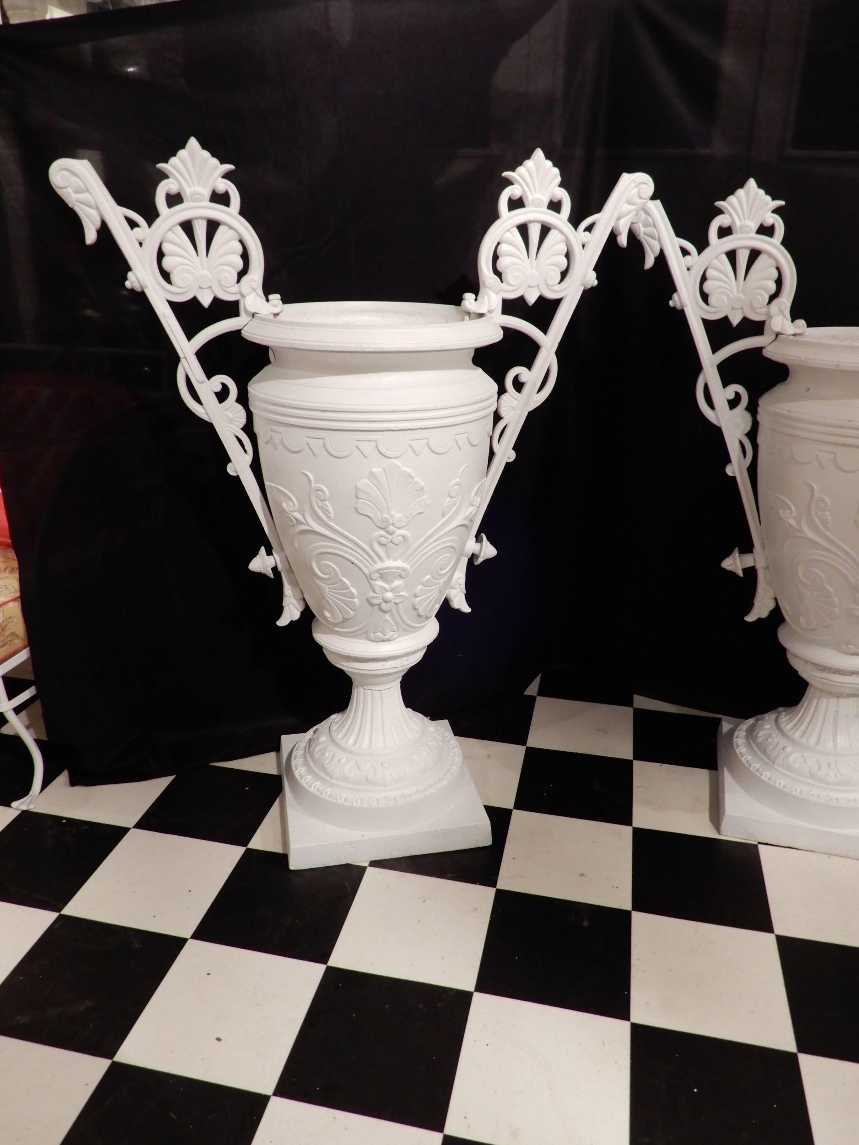 A pair of elaborate 19th century urns in the Renaissance Revival style, often referred to as the Egyptian style in the 19th Century. These urns are by the Mott Foundry of NY, who was the chief competitor of Fiske. Several years ago another urn with