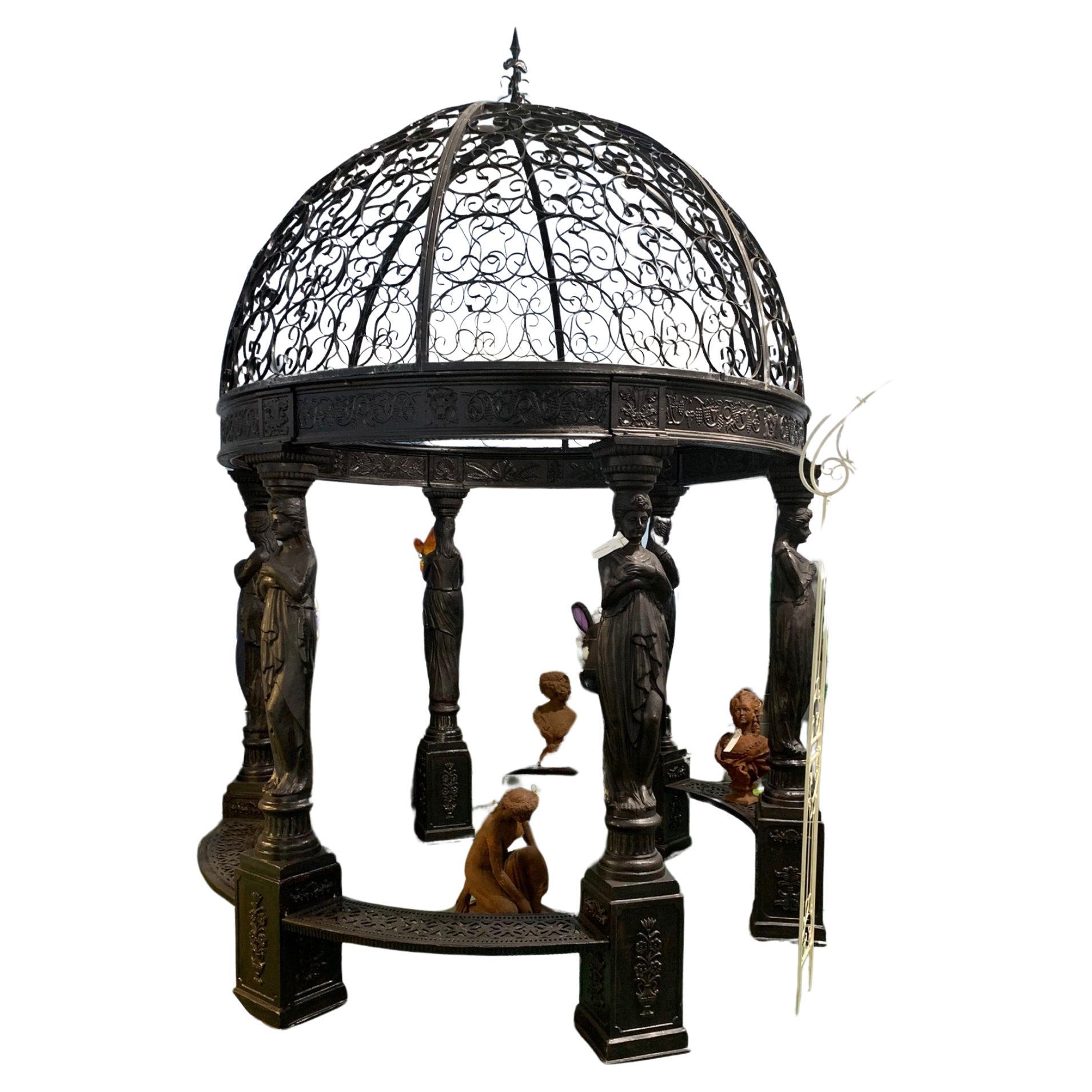 Gorgeous large cast iron gazebo in the Victorian manner
Get this in time for summer and for Pimms on the lawn
Six architectural maidens act as supports to the canopy
Designed so that vines, creepers and foliage will climb up the structure to offer
