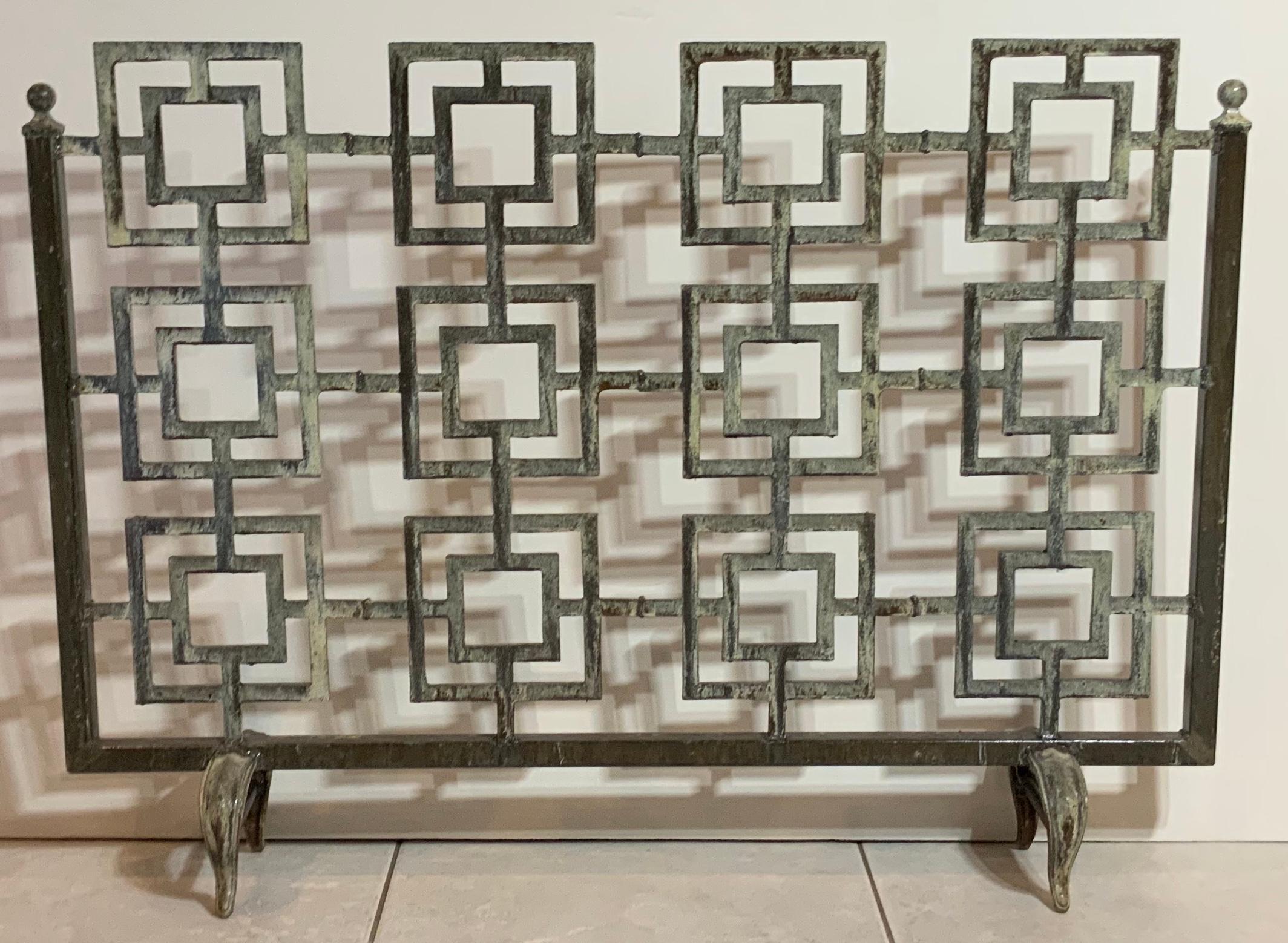 Elegant fireplace screen made of cast iron, artistic motif of squares put together with nice solid frame base. Treated and seal for rust
Beautiful patina. Fine object of art for the fireplace.