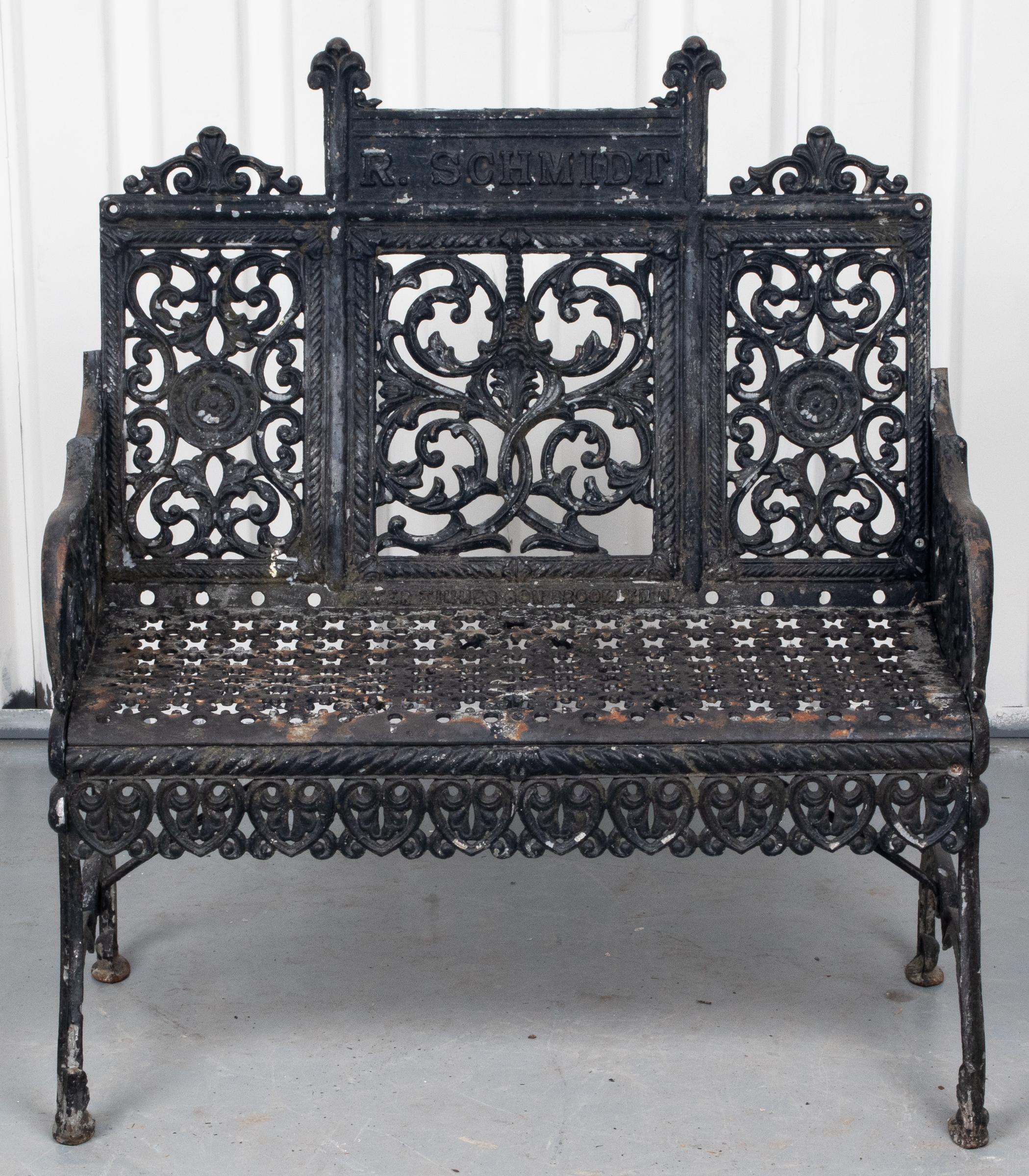 Gothic Revival cast iron garden bench, with black paint decoration and open work motifs, back rest stamped 