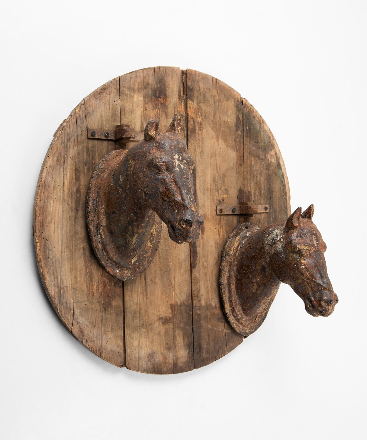 Cast iron horse stabile sign, France, circa 1800.

Cast iron horse heads mounted on original primitive pine board.