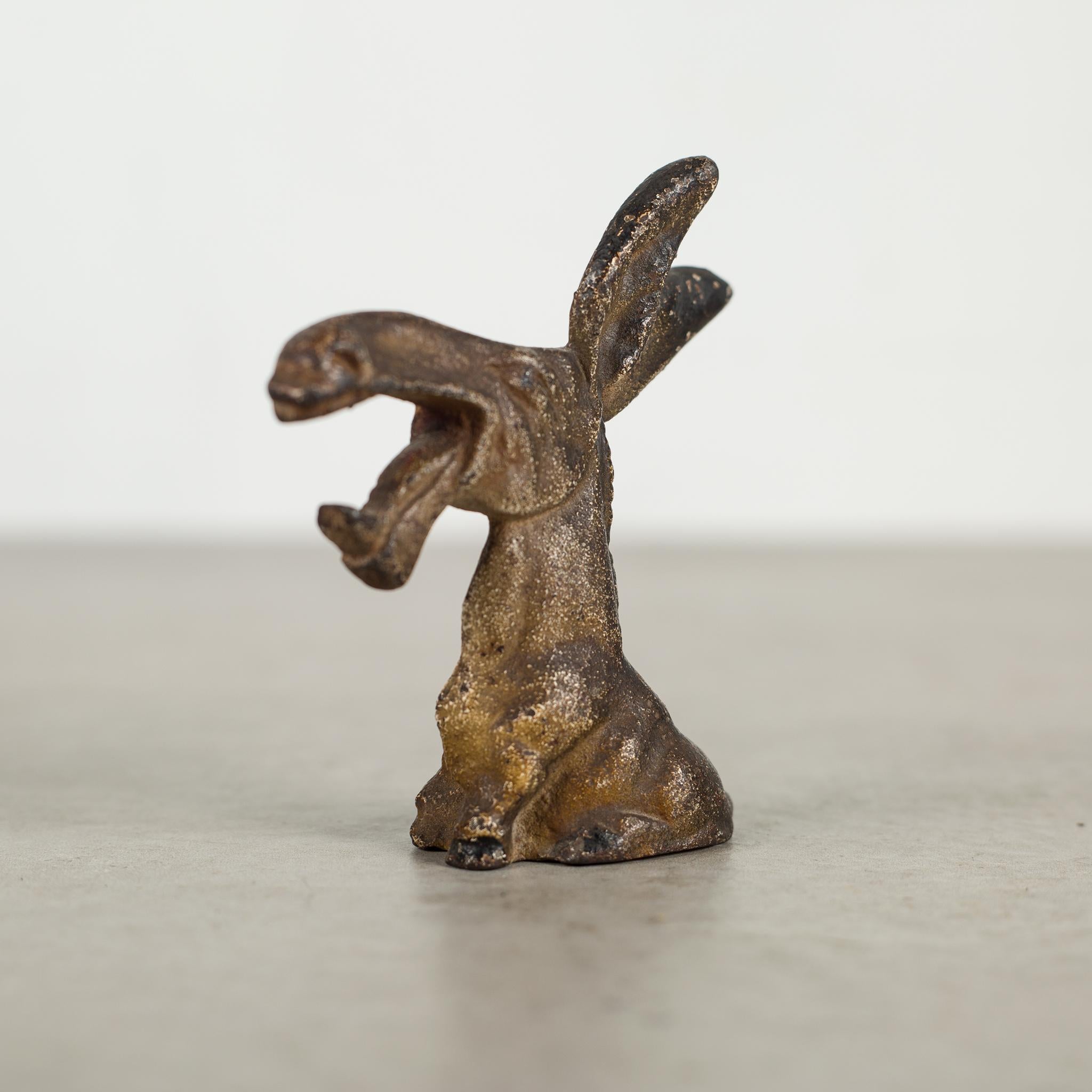 This is an original cast iron donkey bottle opener manufactured by the Hubley Manufacturing Company in Lancaster Pennsylvania, USA. The piece has retained its original hand painted finish and is in excellent condition with the appropriate patina for