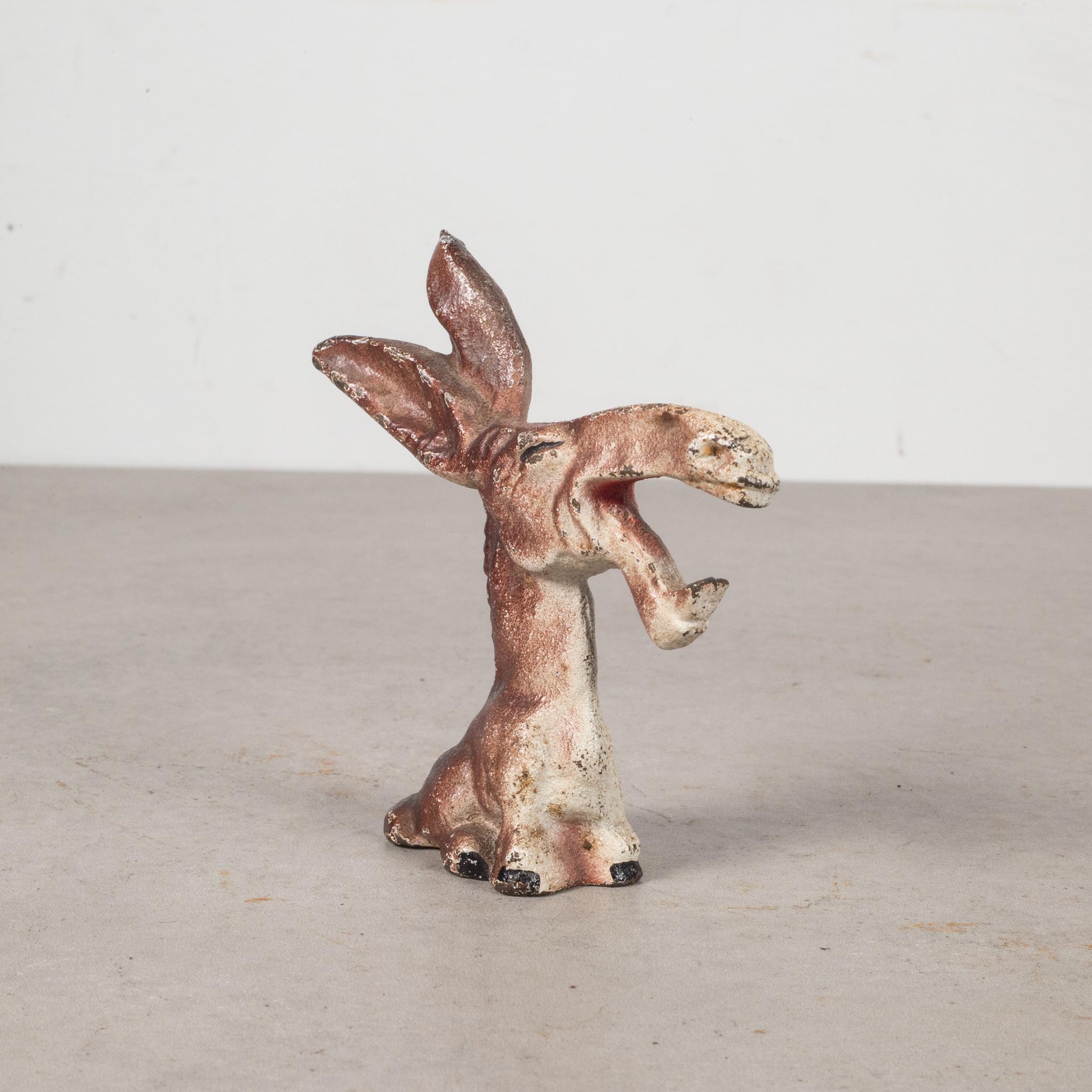 This is an original cast iron donkey bottle opener manufactured by the Hubley Manufacturing Company in Lancaster Pennsylvania, USA. The piece has retained its original hand painted finish and is in excellent condition with the appropriate patina for