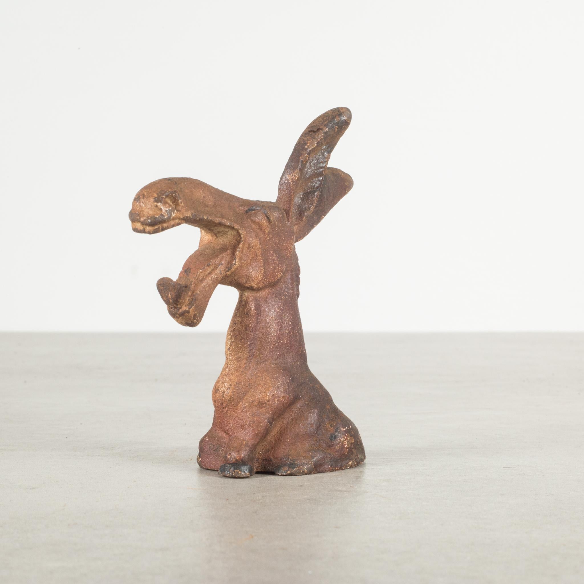 This is an original cast iron donkey bottle opener manufactured by the Hubley Manufacturing Company in Lancaster Pennsylvania, USA. The piece has retained its original hand painted finish and is in excellent condition with the appropriate patina for