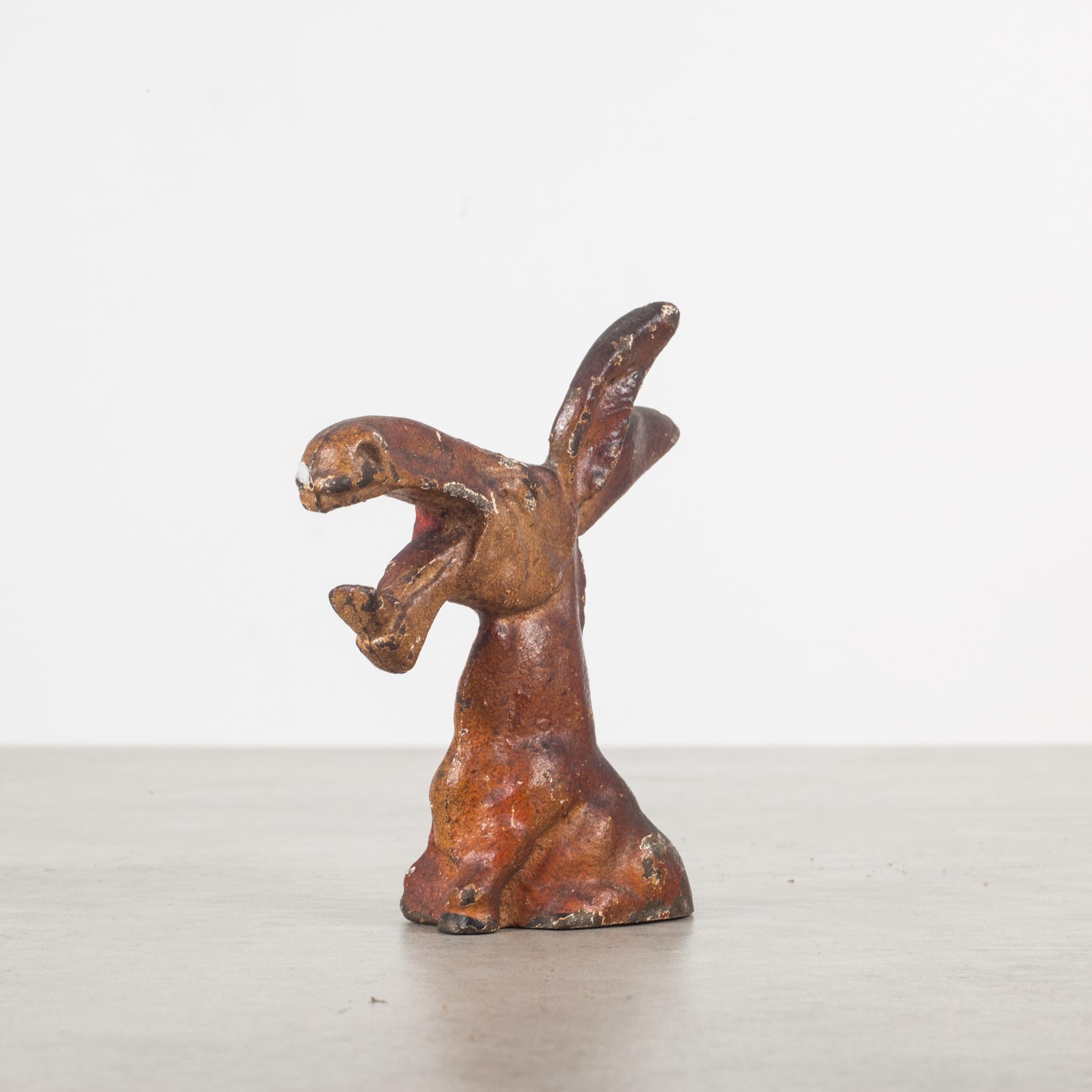 This is an original cast iron donkey bottle opener manufactured by the Hubley Manufacturing Company in Lancaster Pennsylvania, USA. The piece has retained its original hand painted finish and is in excellent condition with the appropriate patina for