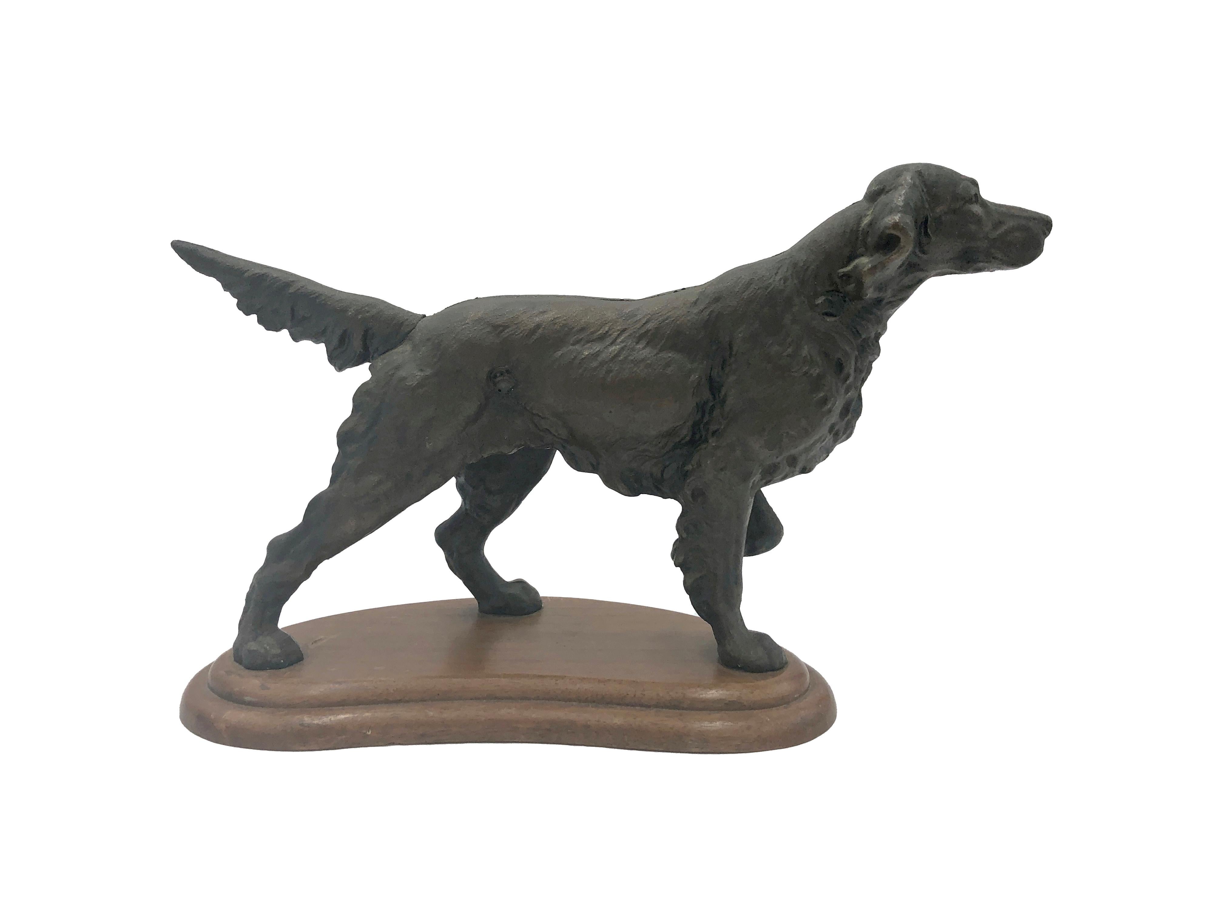 Antique cast iron dog statue of a black pointer made by Hubley. These were often used as door stops. Featuring a kidney shaped wood base with slotted screws. This can be seen at our 333 West 52nd St location in the Theater District West of Manhattan.