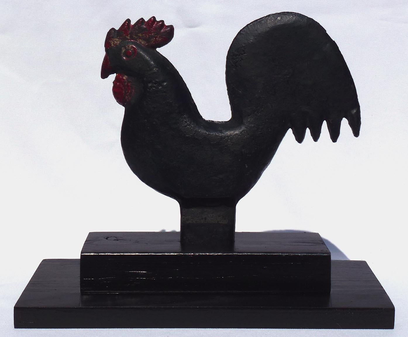 This is a cast iron windmill weight in the form of a rooster. It is a short stem Hummer, made in the early 1900's by the Elgin Wind Power and Pump Company, in Elgin, IL. It has an old repaint of black, red, and white and is in excellent condition.