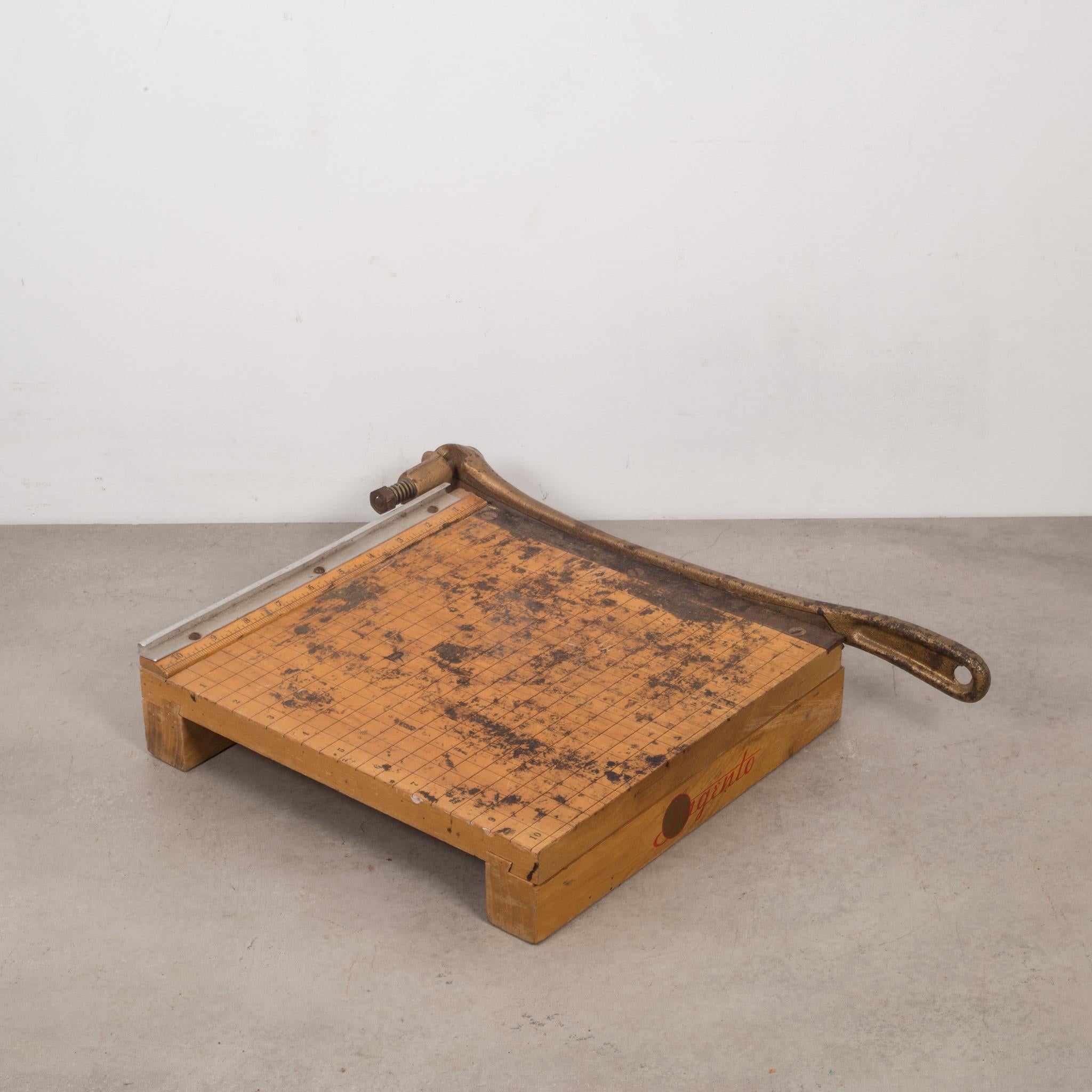 About:

An Ingento no. 3 wood and cast iron guillotine paper cutter. 

Creator: Ingento.
Date of manufacture: circa 1940s.
Materials and techniques: Cast iron, wood.
Condition: Good. Wear consistent with age and use. Works well. Cuts paper properly.
