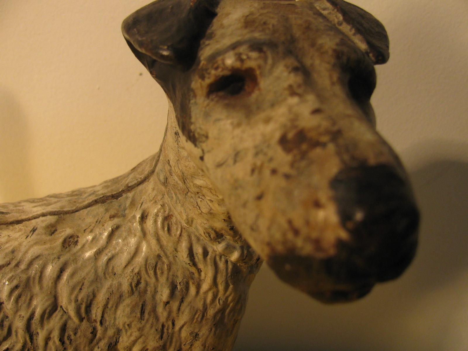 Cast iron door stop in the form of a Jack Russell Terrier. Original paint with some very old touch ups in black.