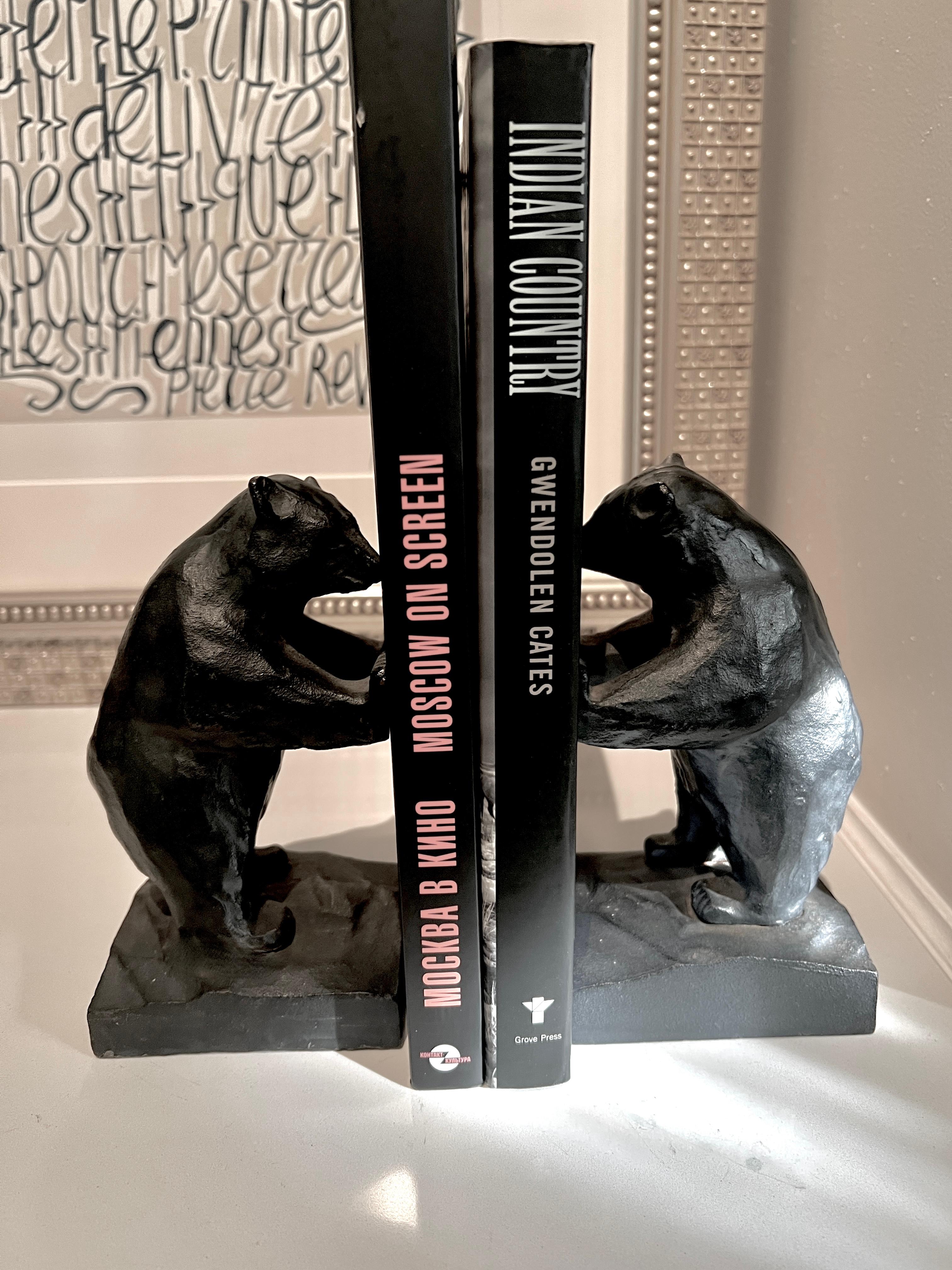 A pair of unique and bold bookends of iron in the shape of two large bears holding your small  to larger bookends

The pair are a compliment on any shelf,  in the library, Den or office, on  desk or work station.  Also a perfect pair in a Childs