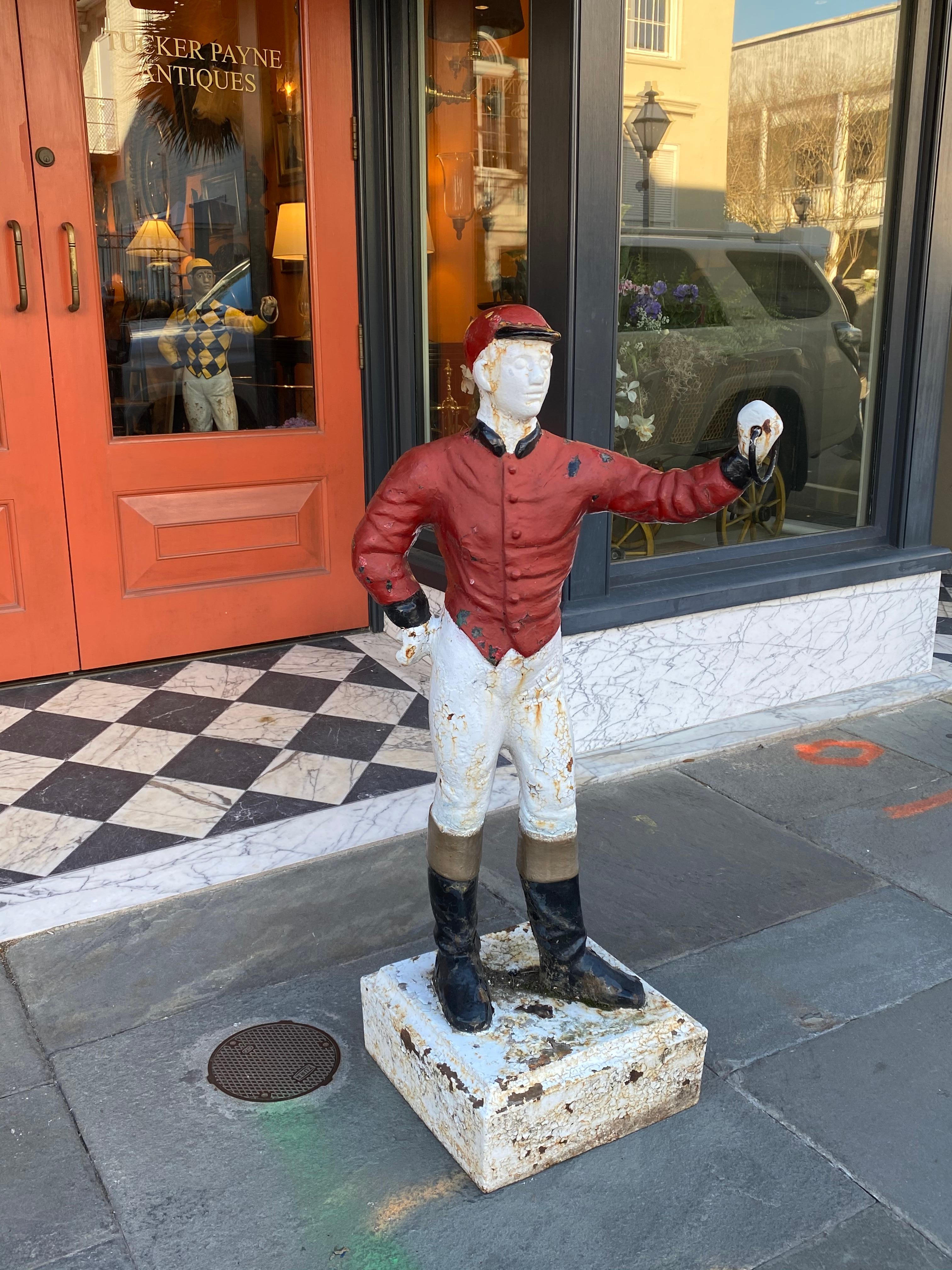 Cast iron lawn jockey from the 1920s, in red and white paint.