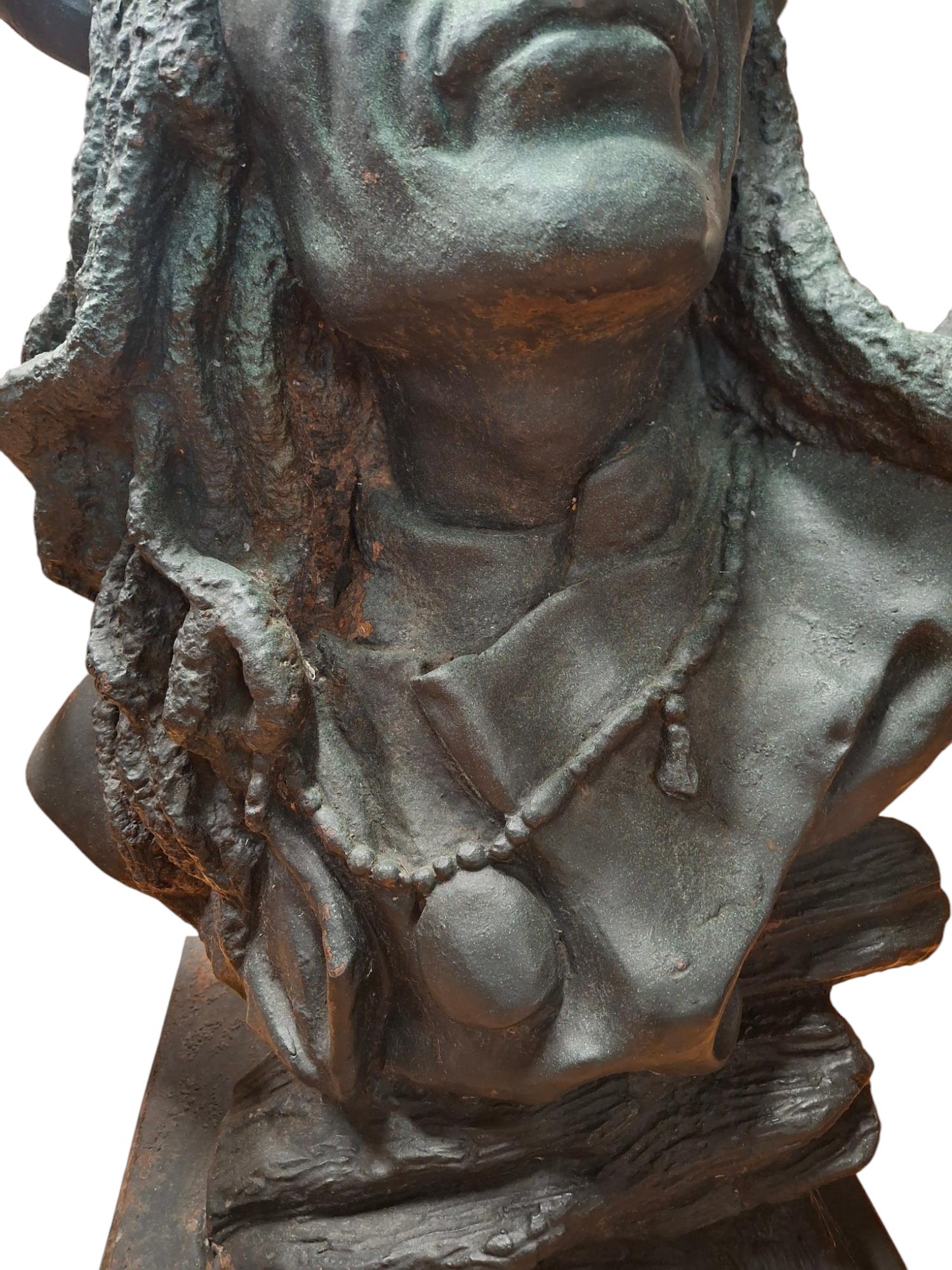 Impressive cast iron bust of a Native American chief displaying a look of true pride.  His headdress, adorned with buffalo horns, a traditional symbol of his bravery and leadership. Only the most honored warriors wore such regalia, making it a
