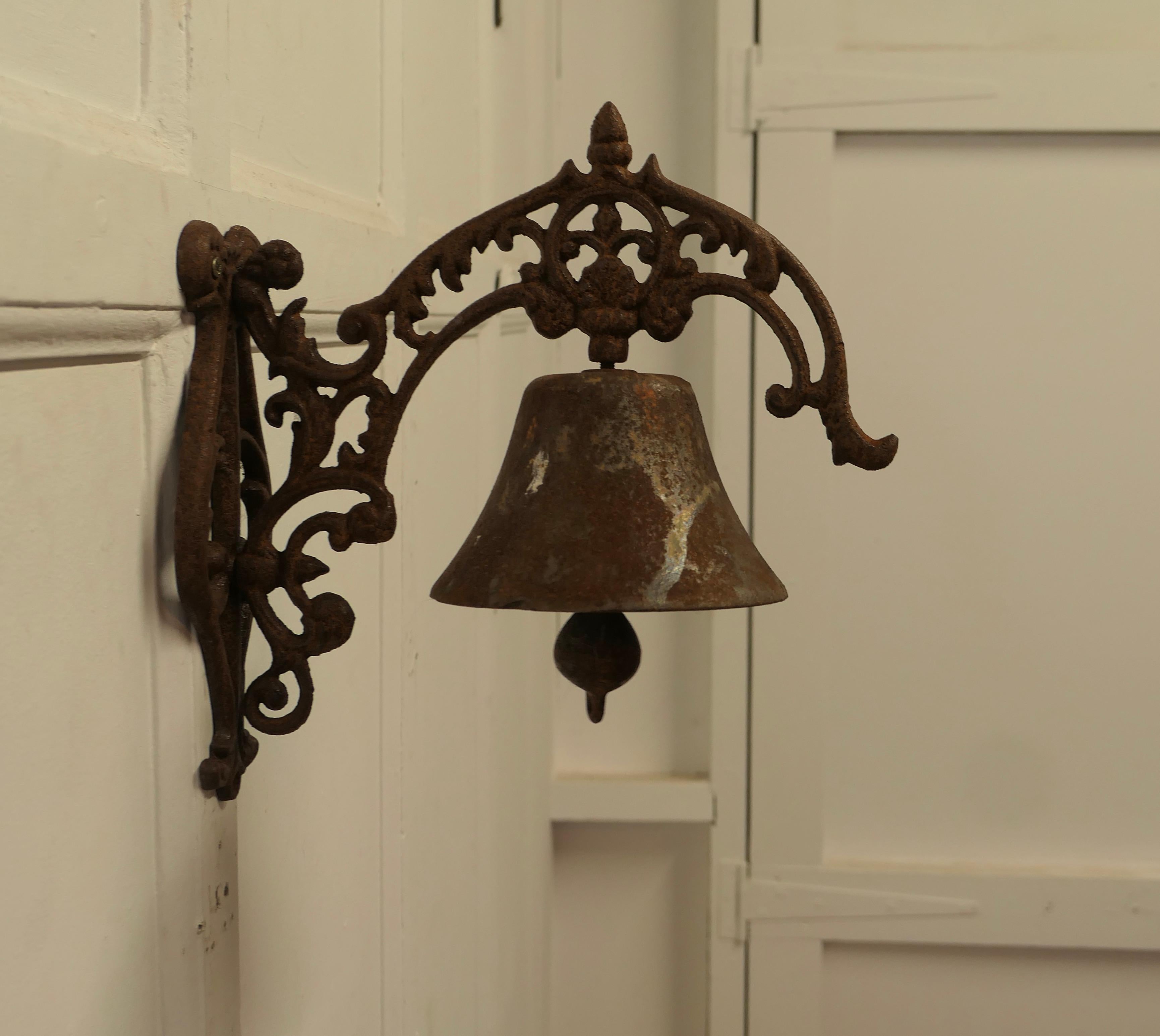  Cast Iron Out Door Bell on Bracket 

This is well weathered out Door Bull Bell on a decorative iron wall bracket, this is a good bell complete with clapper, it is in a weathered condition, it is loud and would work well as a door bell or to call