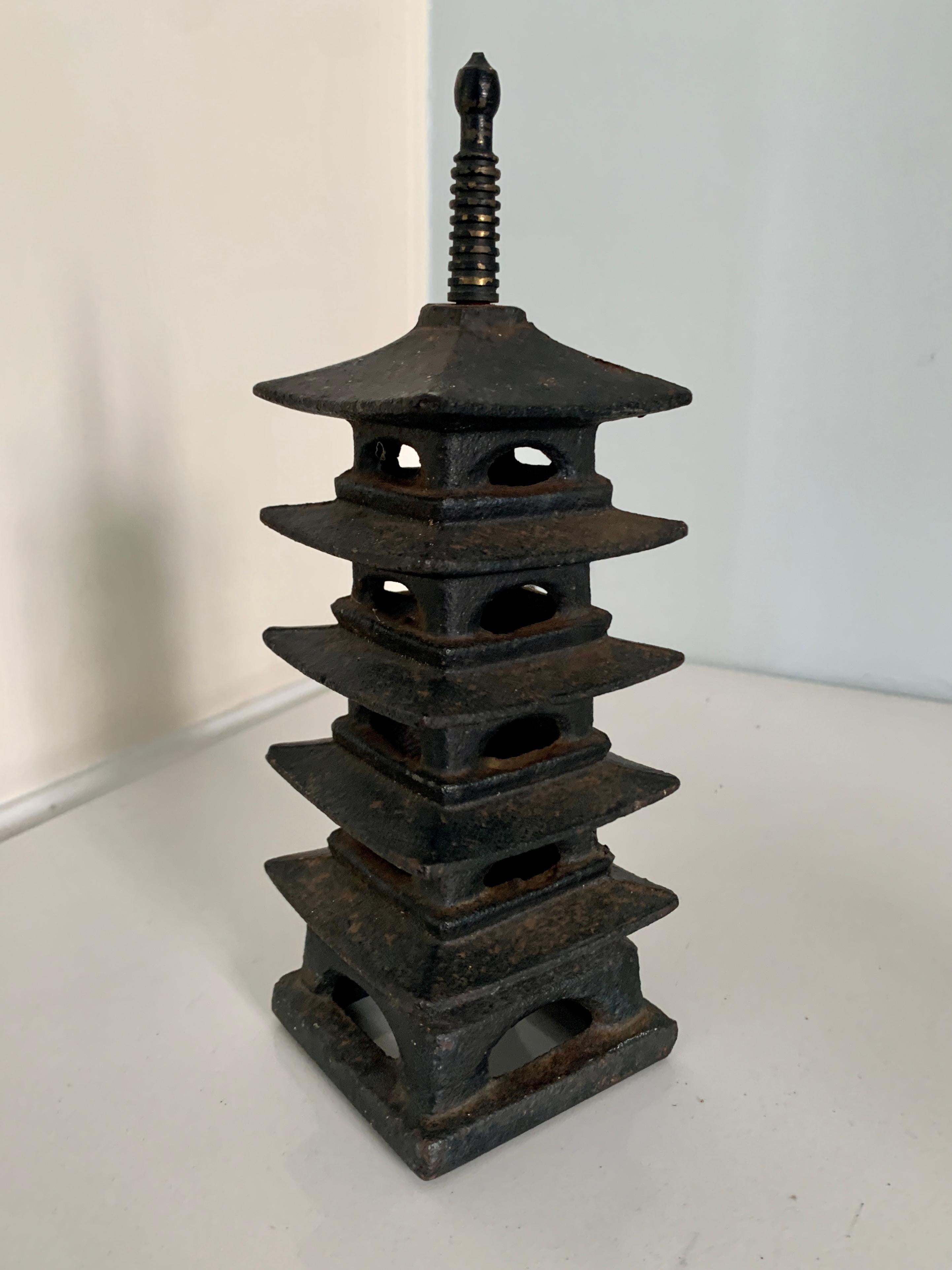 A wonderful and heavy cast iron Pagoda censer. lovely for burning incense, a small, yet quiet statement piece - A compliment to any shelf or console and also a nice addition to any garden table. See images as we have placed Both a tea light and a