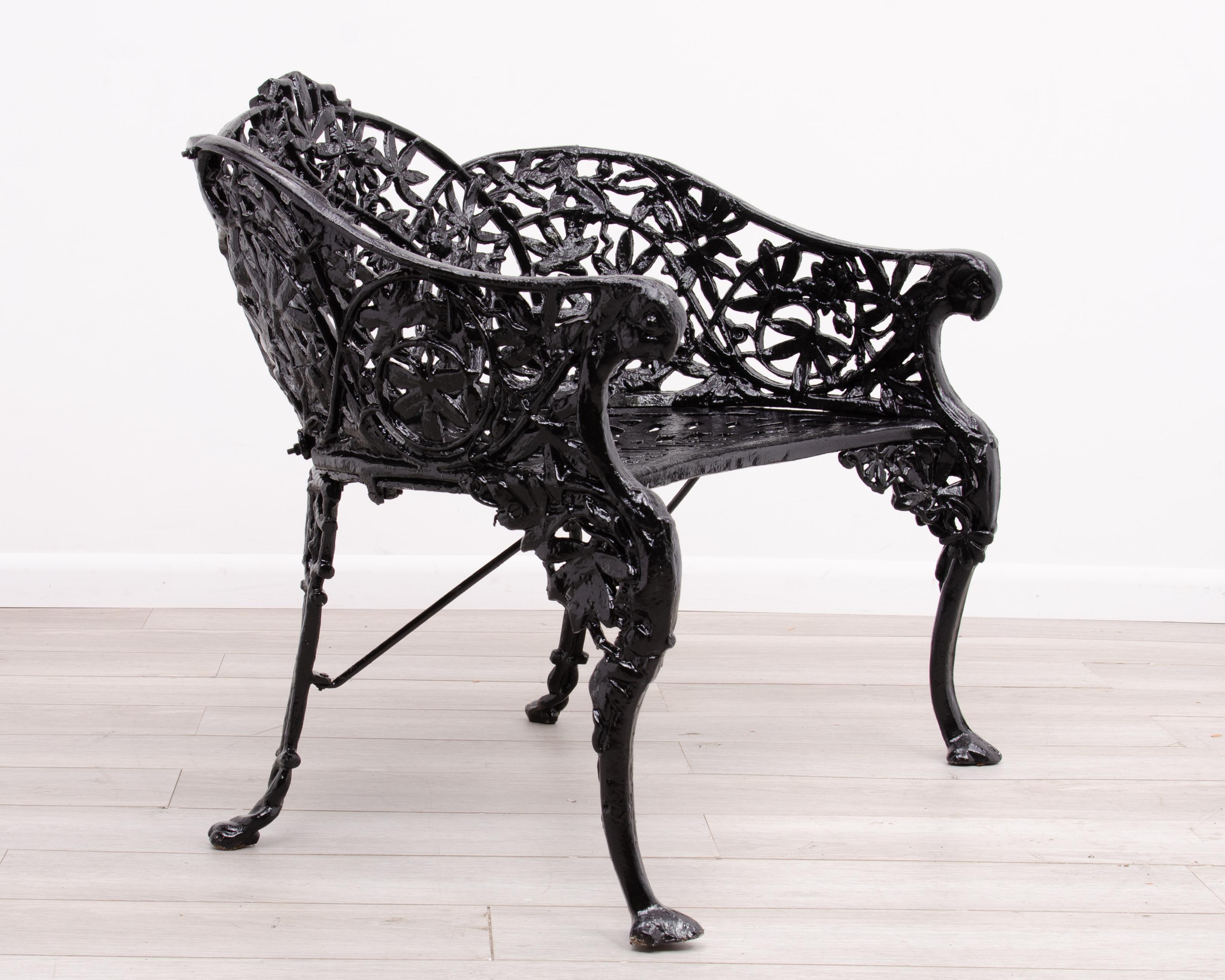 A rare Cast Iron Bench in the elaborate Passion Flower Pattern. This early botanical design originated in England and was registered in 1862 by the Coalbrookdale Company and was then copied by American foundries. The seat features scrolling curved