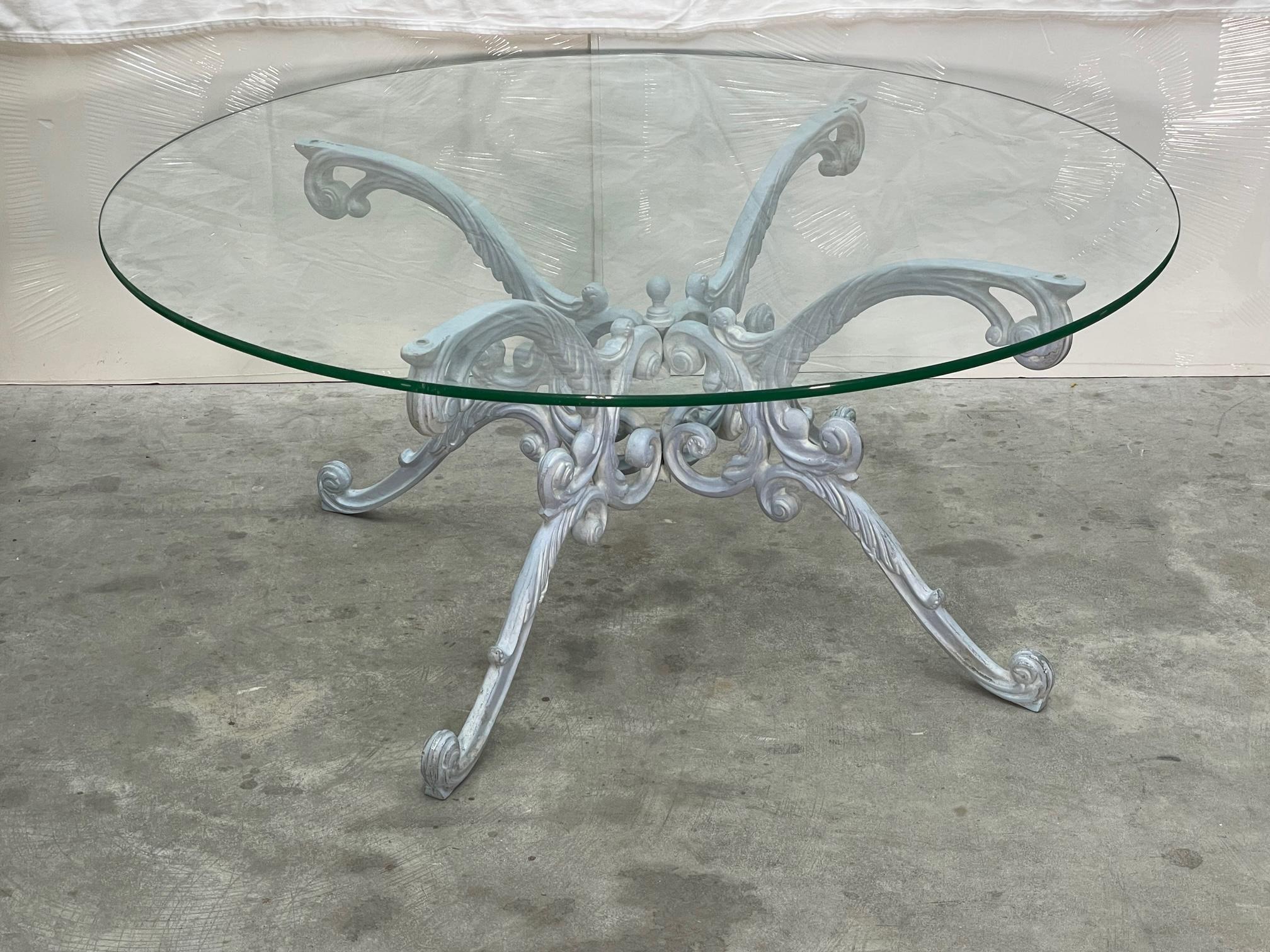 Cast iron coffee or cocktail patio table by Woodard features an ornate base and a 42