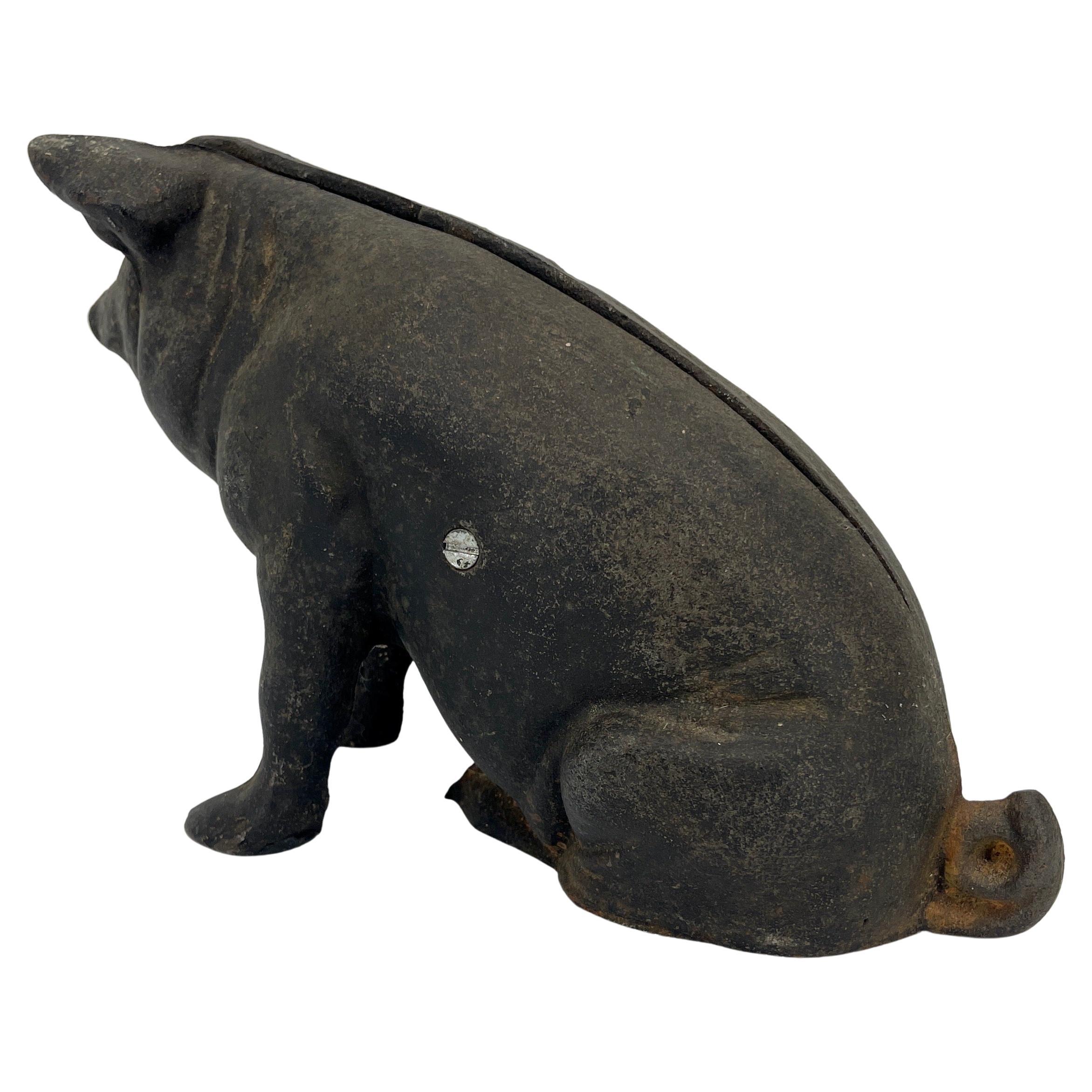 Cast iron pig statue or doorstop. This heavy and adorable pig statue is in very good original condition. Black cast iron pig made in two pieces with screw holding the body together, this enchanting piggy is perfect as a desk accessory or as a door