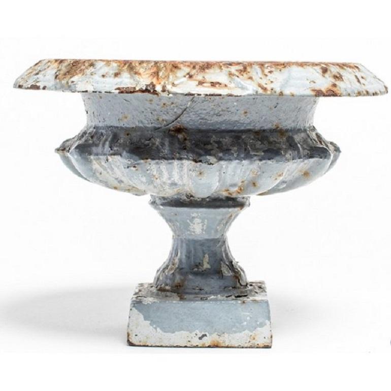 Classic cast iron urn planter made in France circa 1890. This traditional garden element is ideal for elevating greenery for a striking landscape. Heavily patinaed, weathered surface to the painted powder blue finish.

