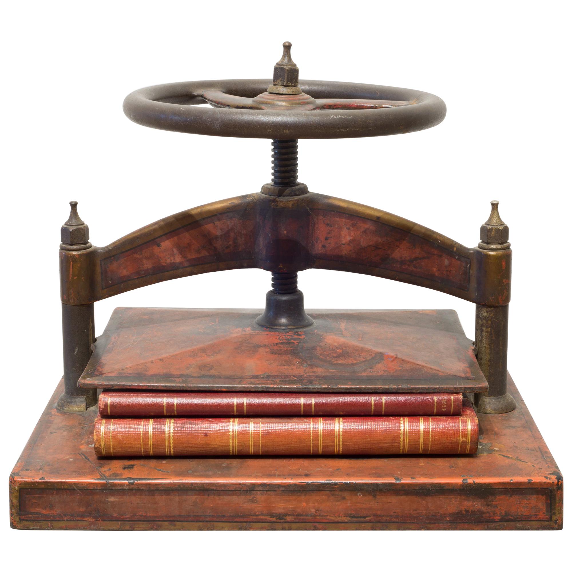 Cast Iron Red Polychromed and Stenciled Wheel Book Press, circa 1930