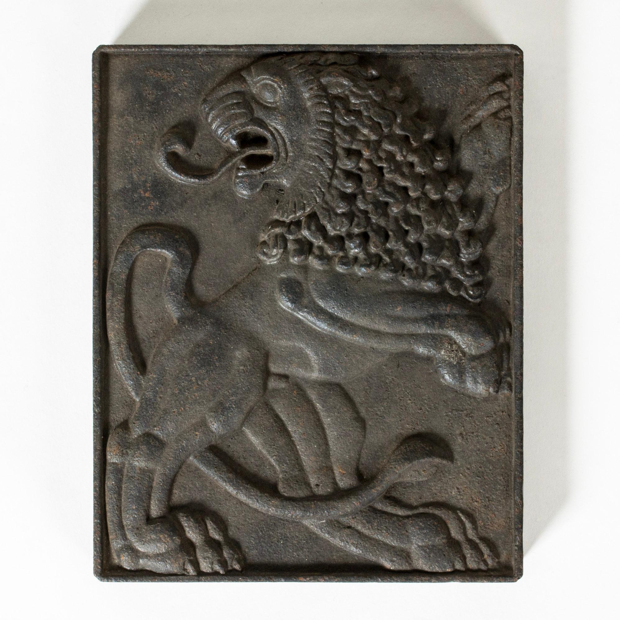 Striking relief by Anna Petrus, made from cast iron. Beautiful, energetic motif of a lion with a flowing mane on its back paws, great attention to detail.

Anna Petrus was a Swedish sculptor, industrial designer and dancer with a unique, powerful