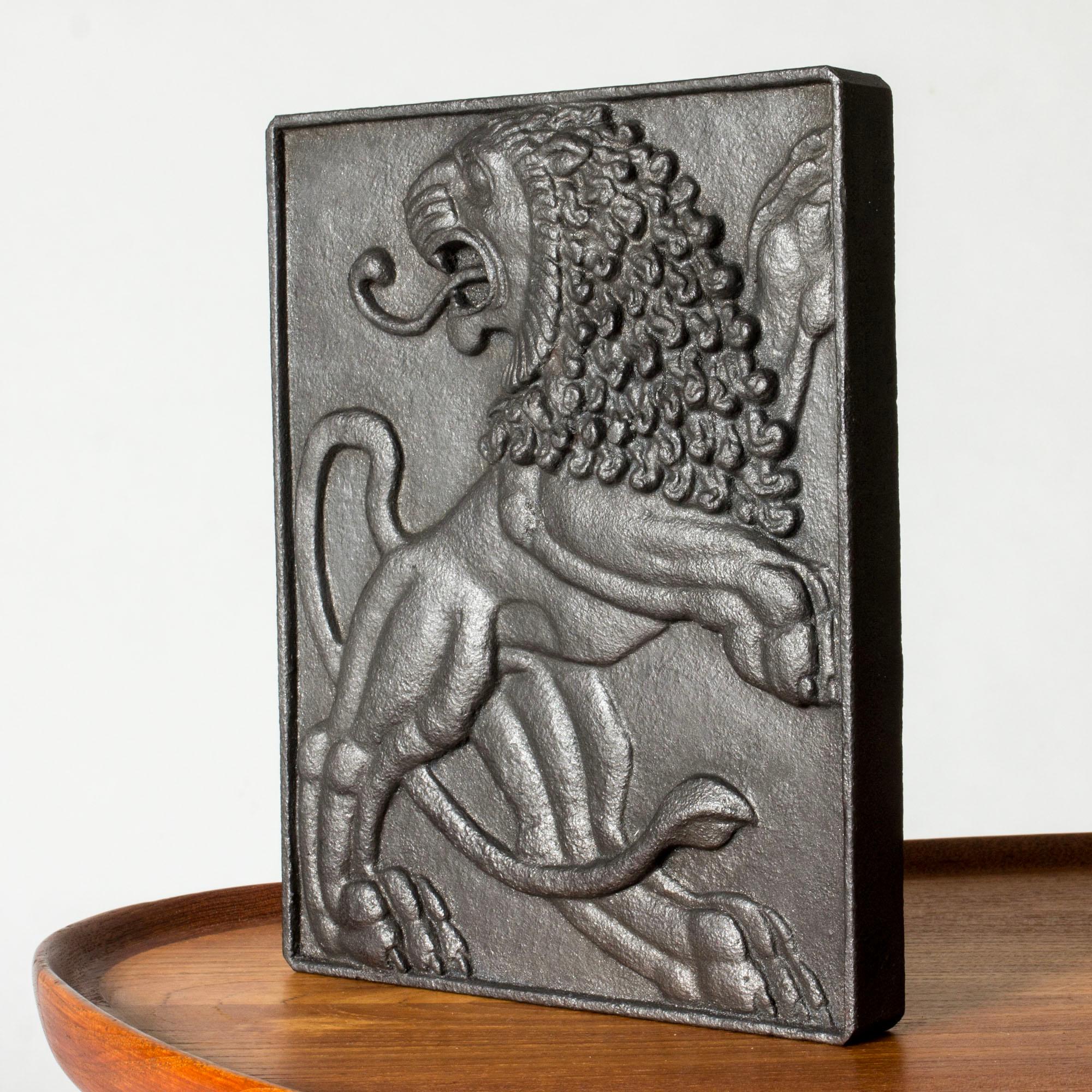 Striking relief by Anna Petrus, made from cast iron. Beautiful, energetic motif of a lion with a flowing mane on its back paws, great attention to detail.

Anna Petrus was a Swedish sculptor, industrial designer and dancer with a unique, powerful