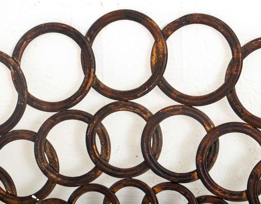 Cast iron ring form mirror, the central round mirror plate encircled by three rings of concentric linked cast iron circles. Mirror: 14.5