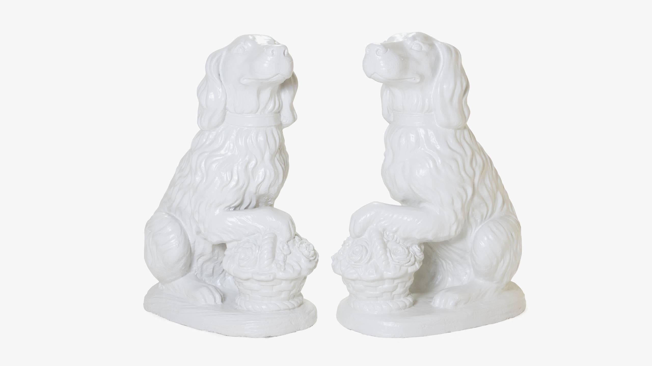 A stately pair of cast iron spaniels resting their paws on blooming floral baskets. The extremely heavy pair have been recently restored with a rich and durable powder coating, a finish that will ensure longevity for generations and allows them to