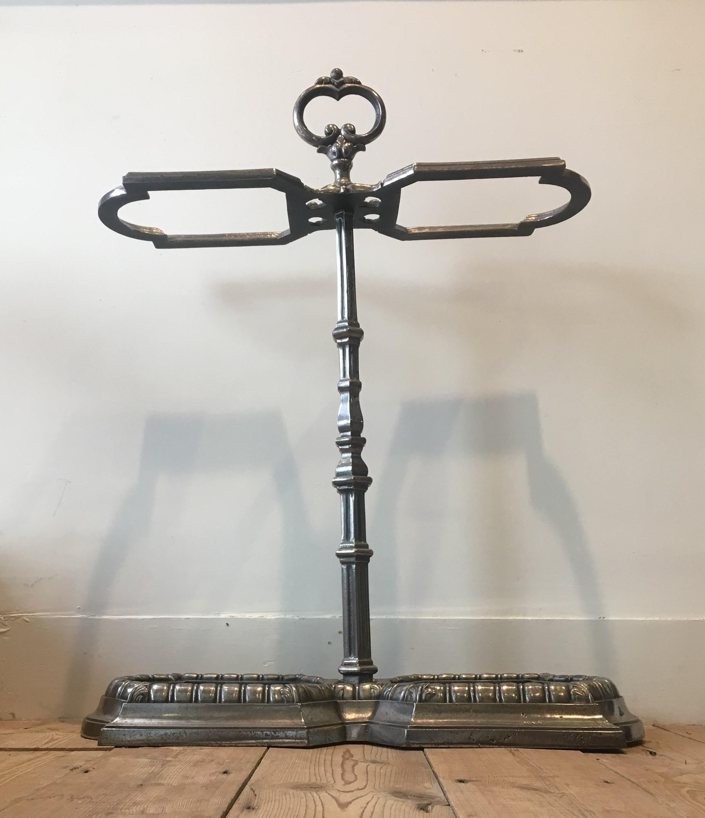 A decorative and substantial polished cast iron Victorian stick stand, circa 1880. Each of the cast iron drip trays may be removed. Measures: height 71cm, width 59cm, depth 23.5cm, England.
 