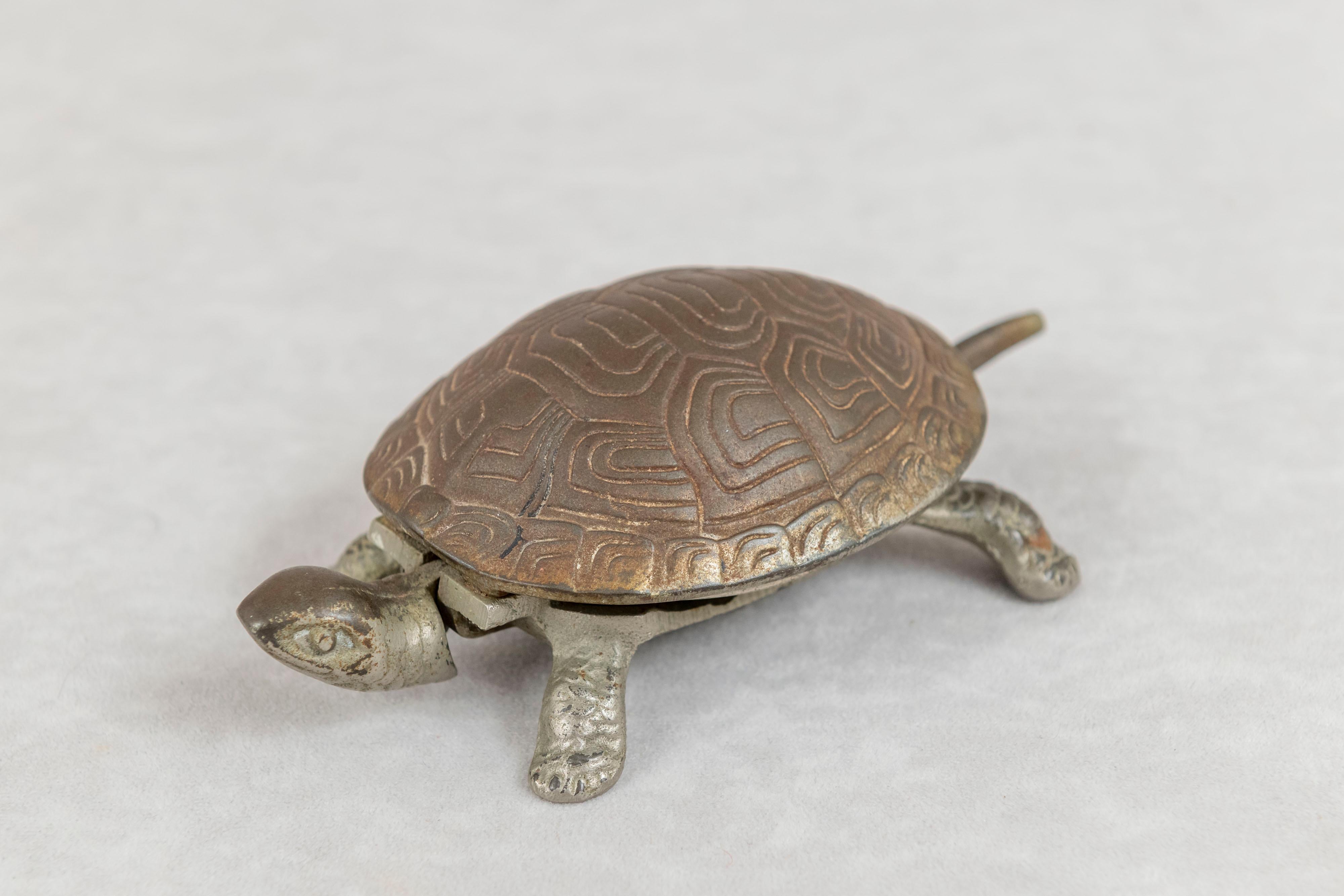 This turtle was used on hotel counter tops to be rung and attract the attention of a staff member. Just tap the turtle on the head to produce this nicely pitched bell sound. The turtle itself is well modeled and nickel plated. The underside reveals