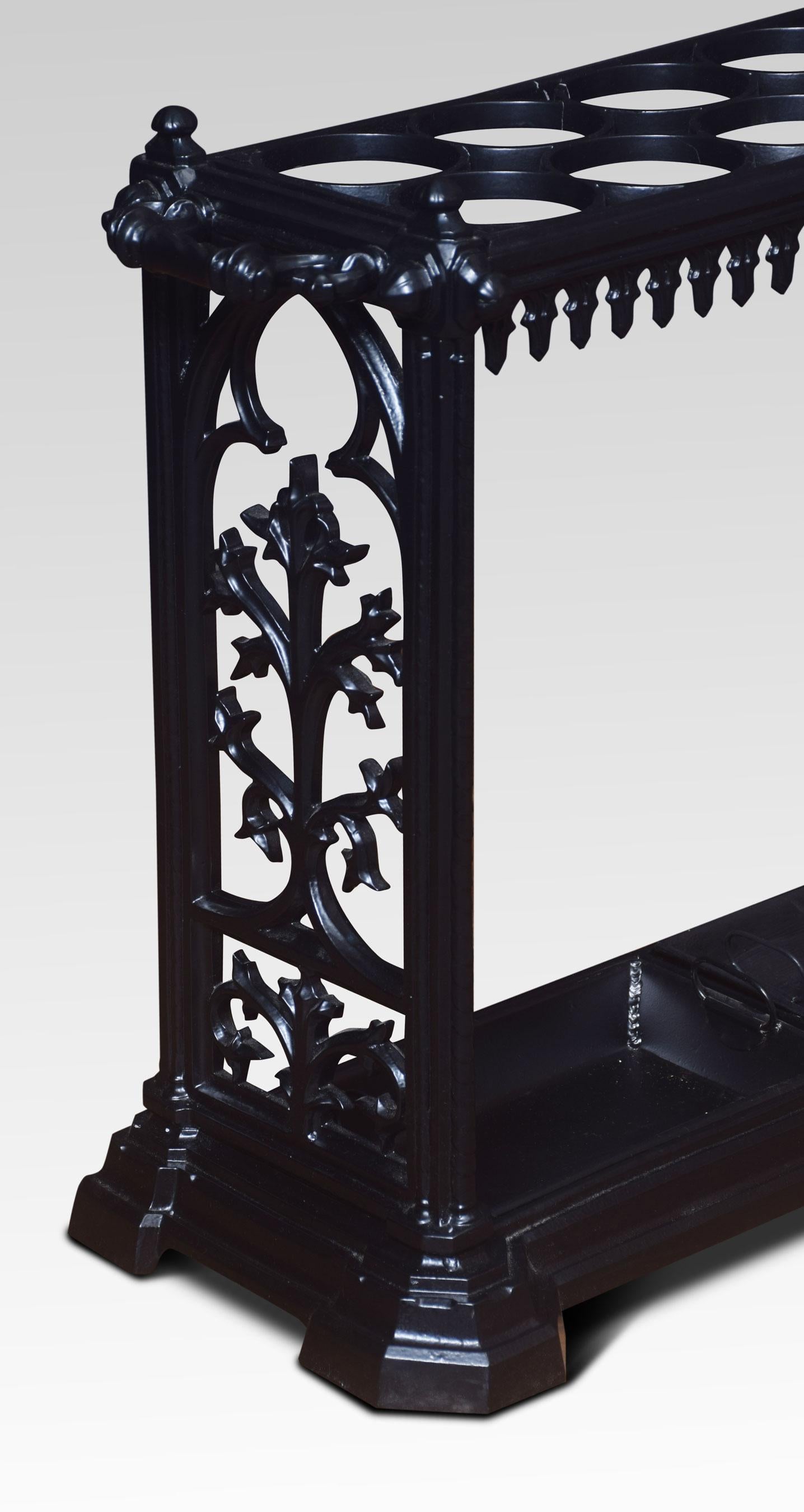 Cast iron twenty-four ring umbrella stand of rectangular form, with raised finials to each corner and circular apertures, the ends with foliated decoration above with drop-in drip trays and cast base.
Dimensions:
Height 23 inches
Width 55