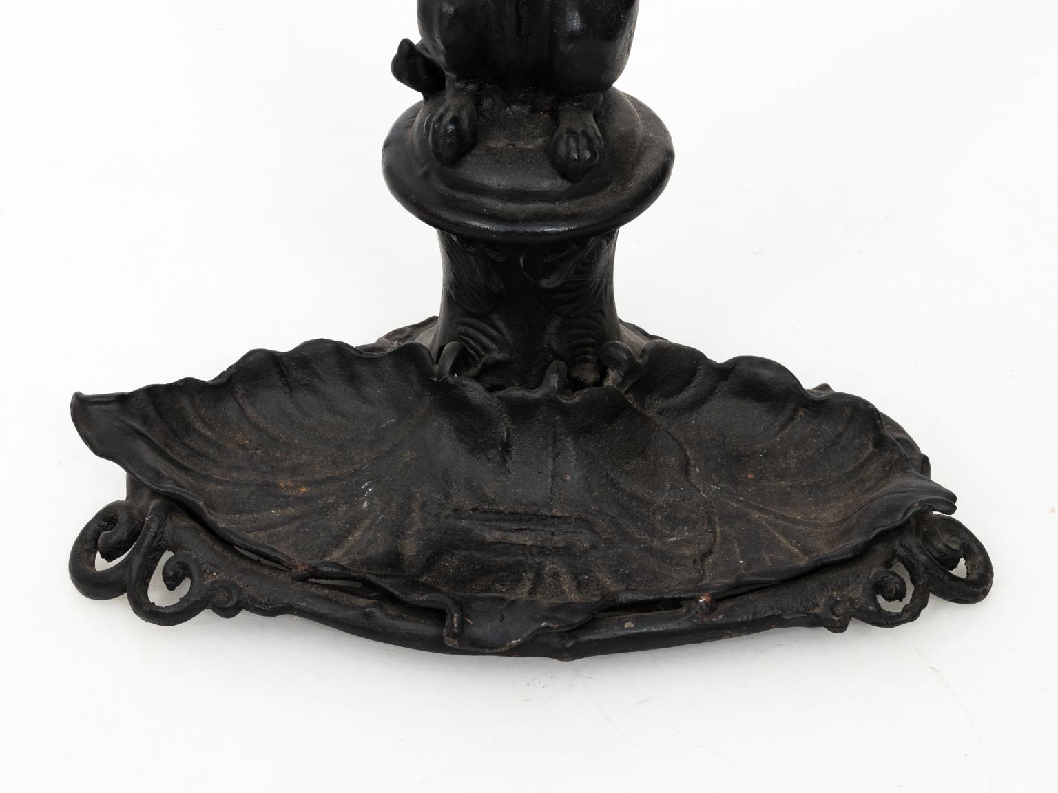 Black painted cast iron umbrella stand depicting a fox holding a riding crop in its mouth while standing on hind legs. Please note of minor oxidation on the base due to daily use. Weight of piece is more than 70 LBS.
   