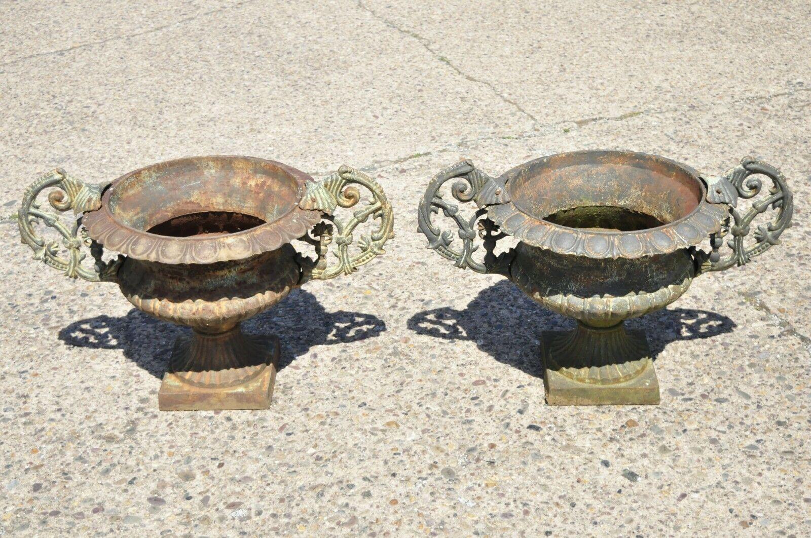 Cast Iron Victorian Style Urn Form Garden Planters with Handles - a pair. Item features attractive weathered finish, nice iron casting, pedestal base, great style and form. Approx. 120lbs each. Circa Late 20th Century. Measurements: 24