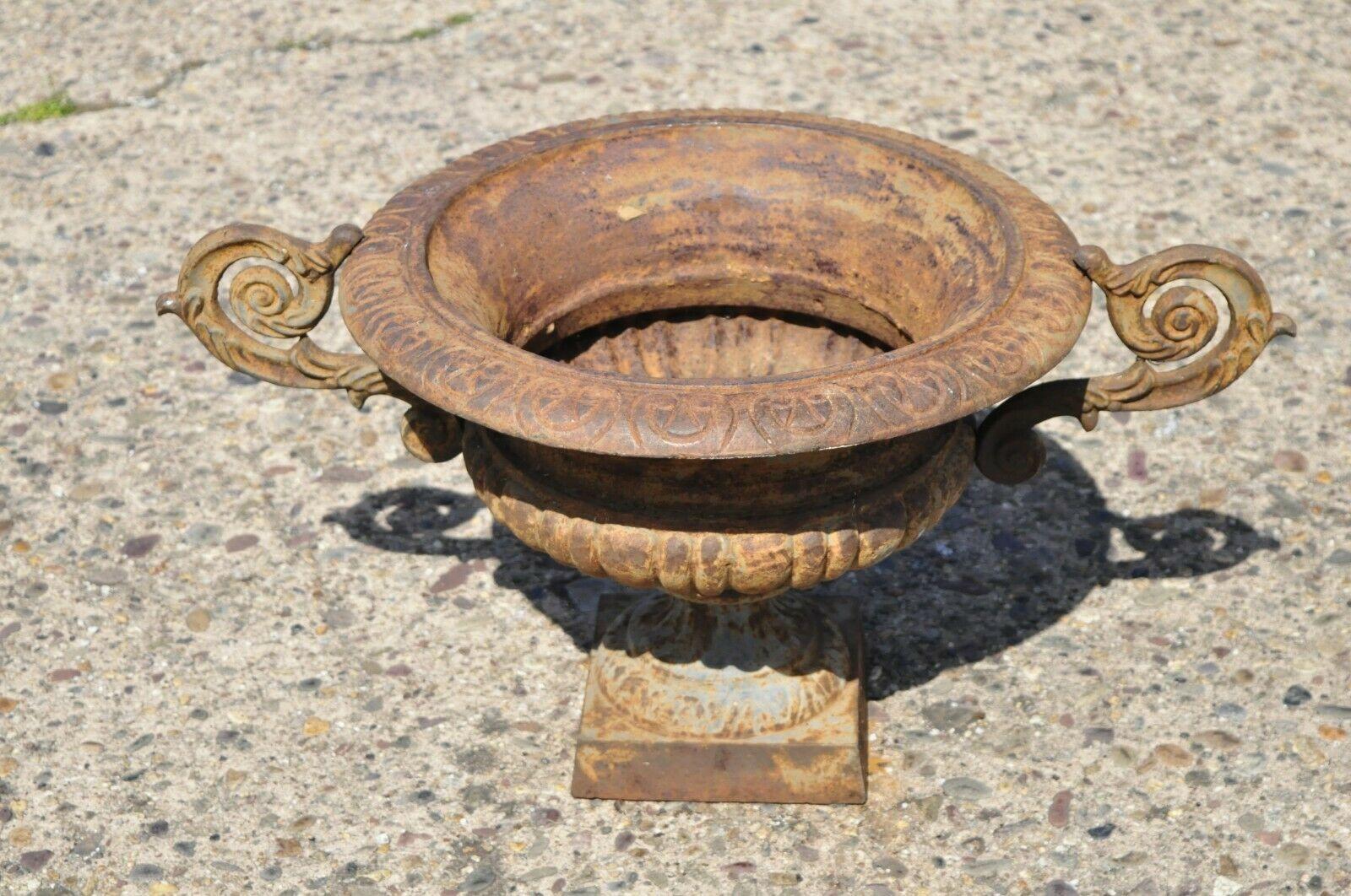Cast Iron Victorian style weathered urn form pedestal garden planter with twin handles. Item features heavy cast iron construction, urn form, twin handles, distressed finish, great style and form, approx. 50lbs. Circa late 20th century.