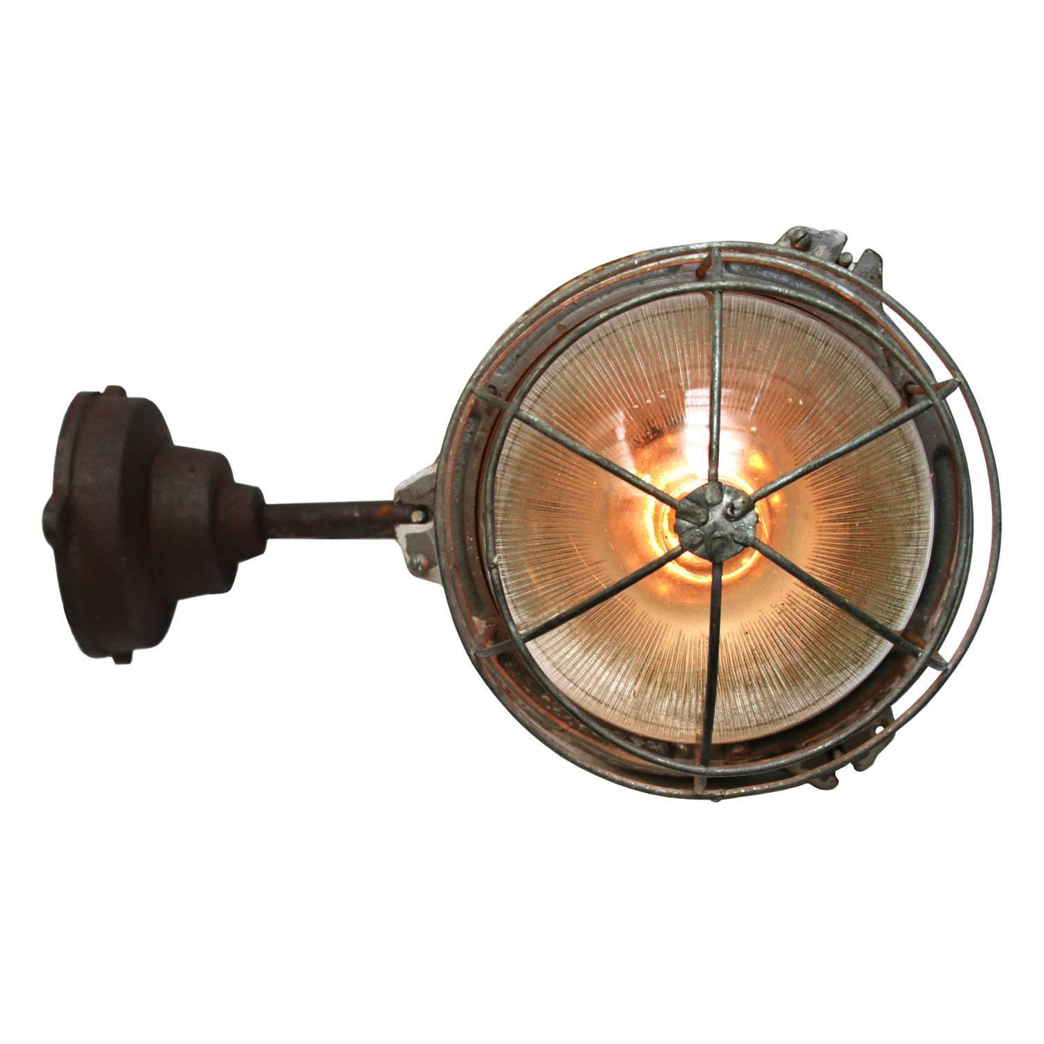 Cast iron Industrial wall light. Holophane glass. 

Weight: 7.5 kg / 16.5 lb. 

For use outdoors as well as indoors. 

Priced per individual item. All lamps have been made suitable by international standards for incandescent light bulbs,