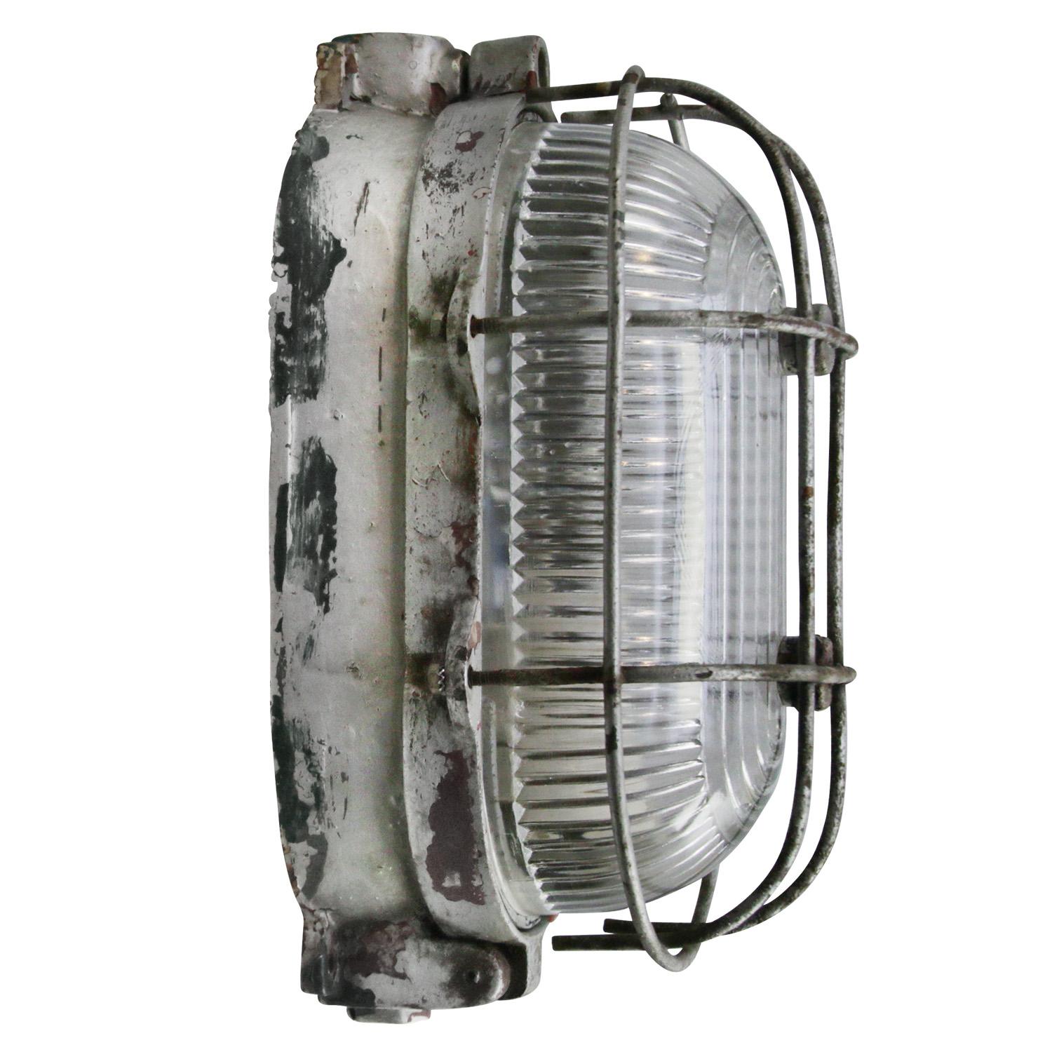 Industrial wall or ceiling lamp
Cast iron, clear Holophane glass

Weight: 3.70 kg / 8.2 lb

Priced per individual item. All lamps have been made suitable by international standards for incandescent light bulbs, energy-efficient and LED bulbs.