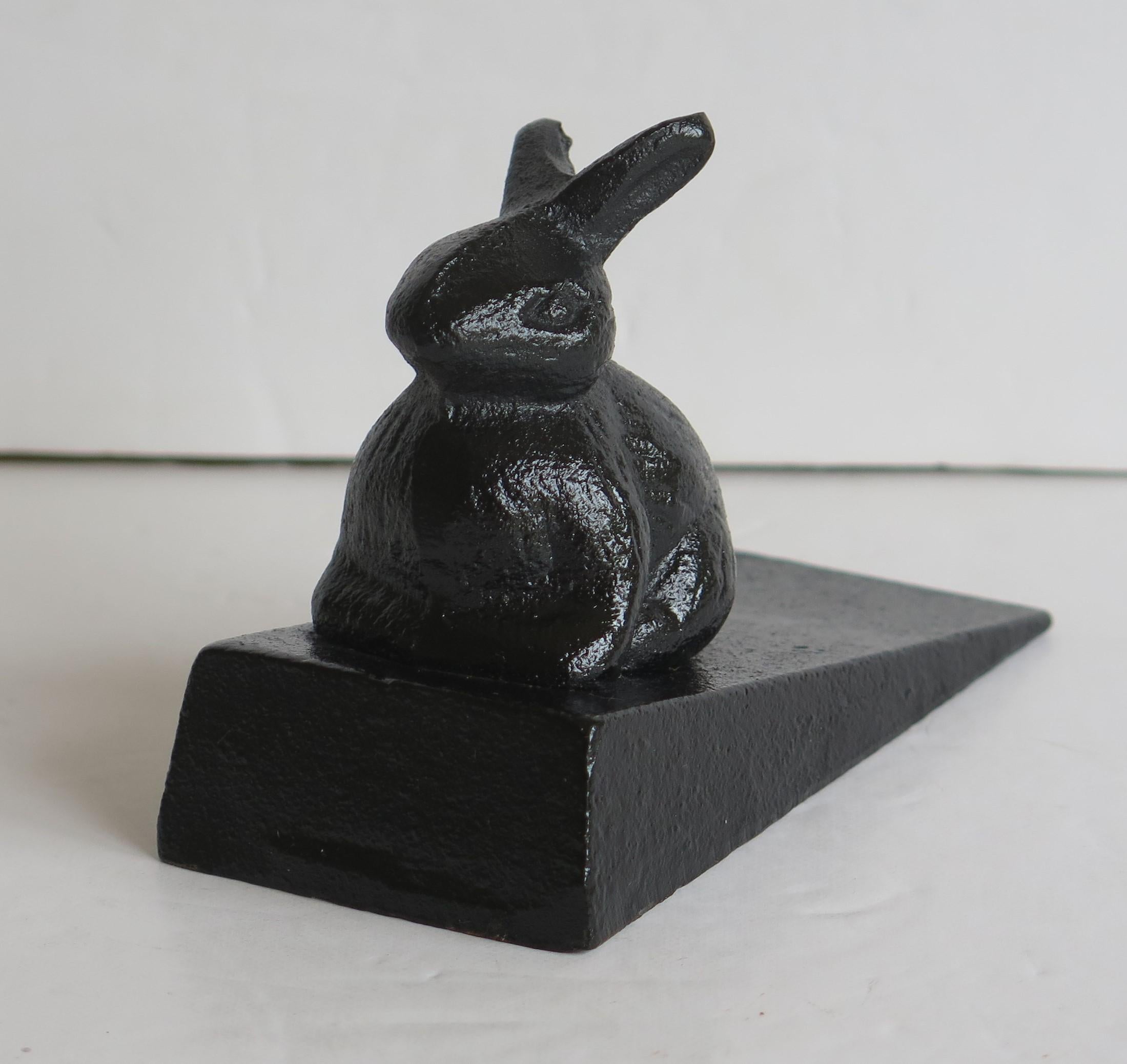 This is a very decorative door stop with a rabbit figure, all in cast iron and dating to the mid 20th century, circa 1940

The piece is well cast out of iron in two parts; the wedge shape base and the Rabbit animal figure, which attaches to the
